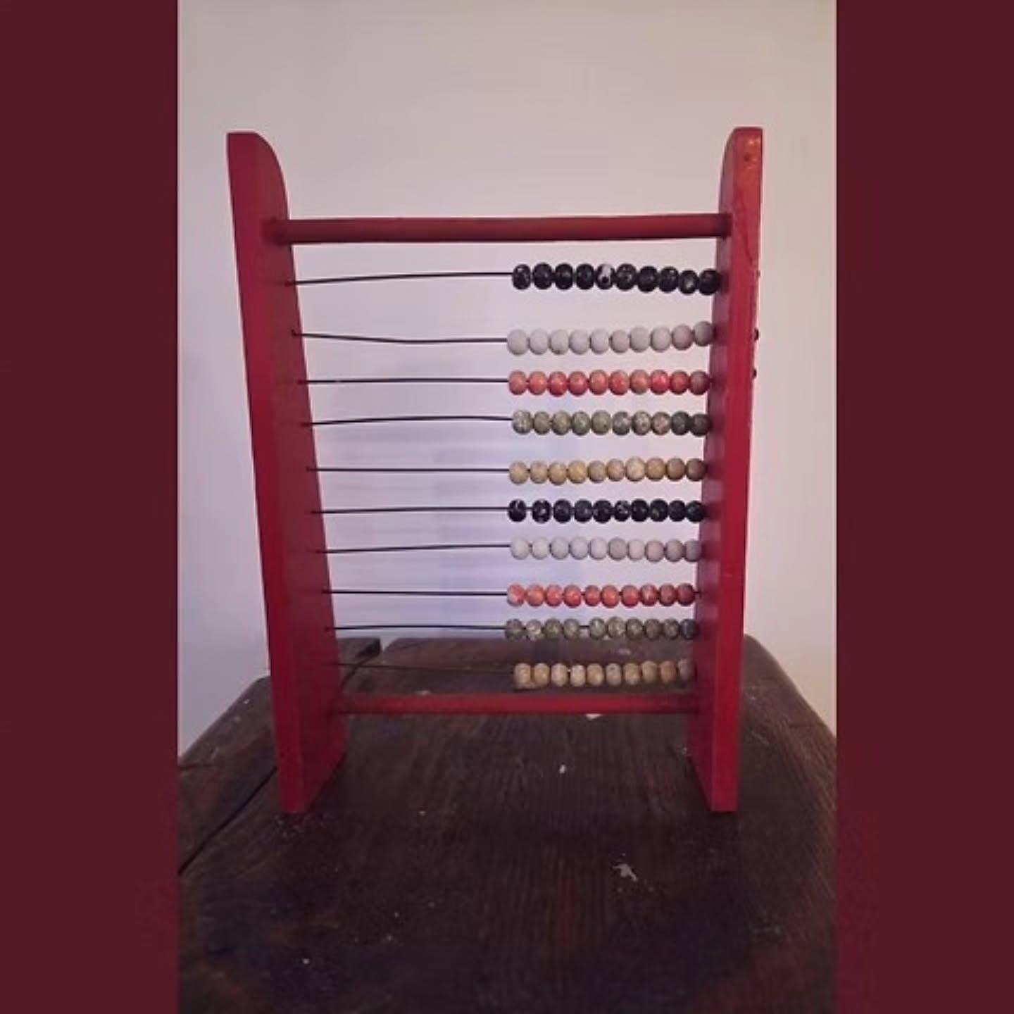 Charming Vintage Red Wooden Abacus — Mid-Century Schoolroom Counting Frame
.
Add a dash of nostalgic school-day whimsy to your home with this delightful vintage abacus.
.
Dating from around the 1940s–1960s, this cheerful counting frame features a bold red painted wooden frame threaded with rows of beautifully worn, hand-painted wooden beads in soft shades of cream, coral, moss green, ochre and black.