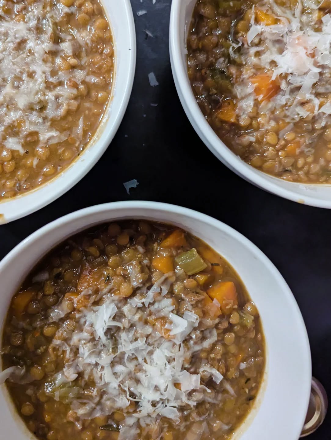 A sign of abundance and prosperity - lentils are a traditional Italian (and Mexican) new year's dish. Similarly, black eye peas are traditional to southern Black celebrations. I currently have a bowl soaking for a porky stew tomorrow. 😋
I received several requests for a recipe of the lentil soup I shared in my stories recently. And here it is 🤌🏽🤌🏽🤌🏽 for your new year's eve. Give this ultra easy and super delicious soup a try and welcome good fortune into your home this year! ✨🙏🏽🤑
Ingredients:
2 yellow onions - diced
3 carrots - diced
3 celery stalks - diced
4 cloves of garlic - minced
1/3 stick of butter
EVOO
1/2 cup of dried porcini - crushed
Brown lentils
Salt
Pepper
Thyme
Rosemary
Allspice
Chili flakes
Parm
✨
Melt butter in a pot with a heavy drizzle of EVOO. Add carrots, celery, onions, salt and pepper, sweat out on medium heat. Stir regularly. Add herbs. Keep stirring. Add porcini. Keep stirring. Add garlic. Keep stirring. Cook until veggies are reduced to a tacky paste. A little bit of browning is desired. Add all spice and chili flakes. Stir. Add water. I'll usually pre boil in an electric kettle to keep the momentum. Add a generous amount of salt. Bring to boil. Add lentils. Bring back to a boil then reduce to simmer. Cook gently until the lentils are tender. Stir to activate starches and thicken the soup. Shave some parm on top and stir in. Serve with cracked black pepper and extra parm shavings. Buon appetito! Buon anno!
#buonappetito
#tradition
#happynewyear
#2026
#abundance