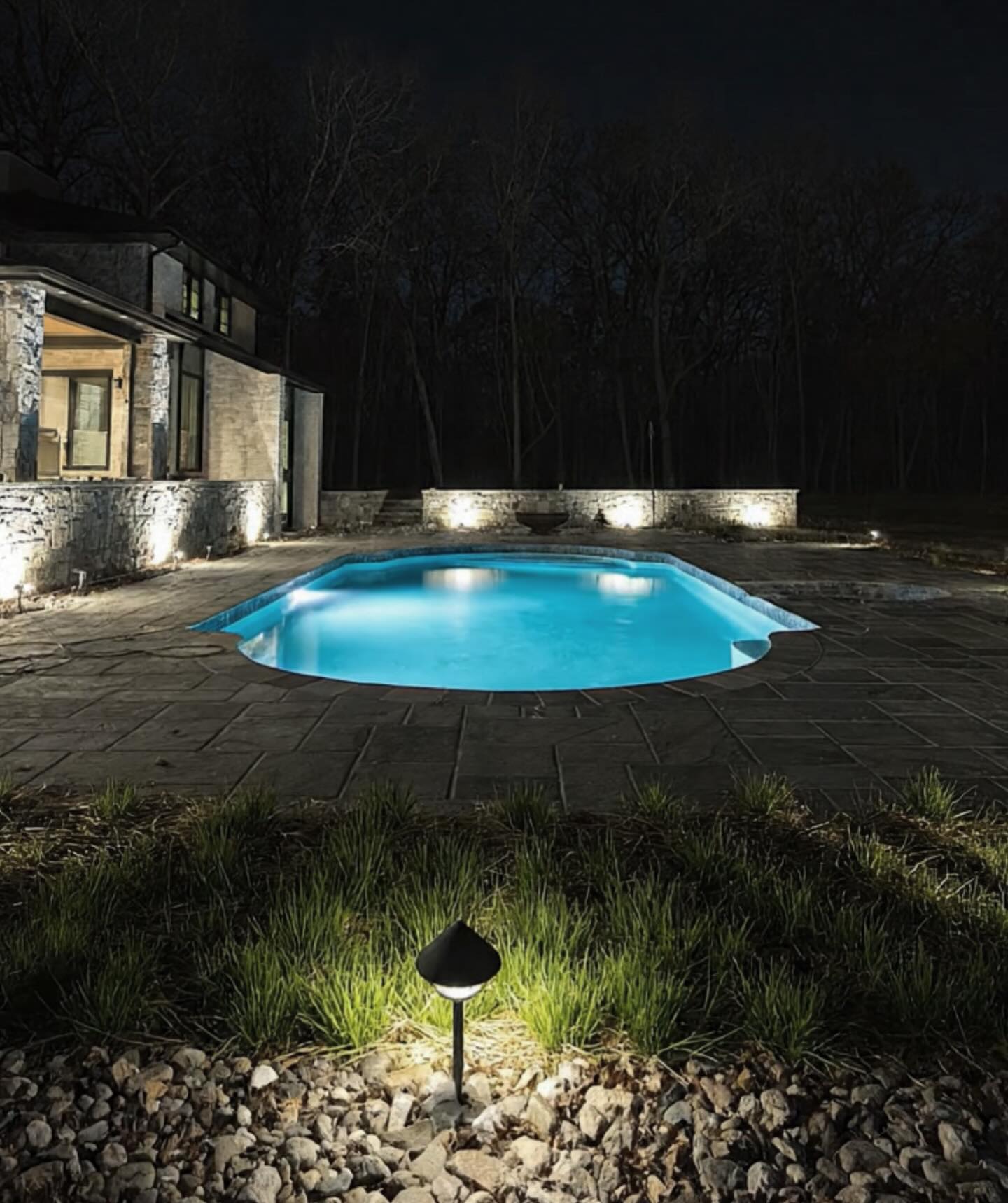 A full natural stone hardscape done around a pool.
