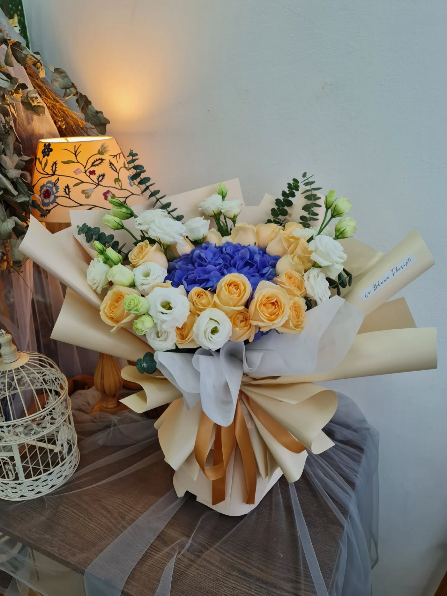 Indulge in the timeless elegance of our Blue Hydrangea with Champagne Rose Bouquet. This exquisite arrangement combines the lush beauty of blue hydrangea blooms with the delicate allure of champagne roses, creating a harmonious blend of colors and textures.
Perfect for celebrating special occasions or adding a touch of sophistication to any space, each bouquet is meticulously crafted to showcase the natural grace and charm.