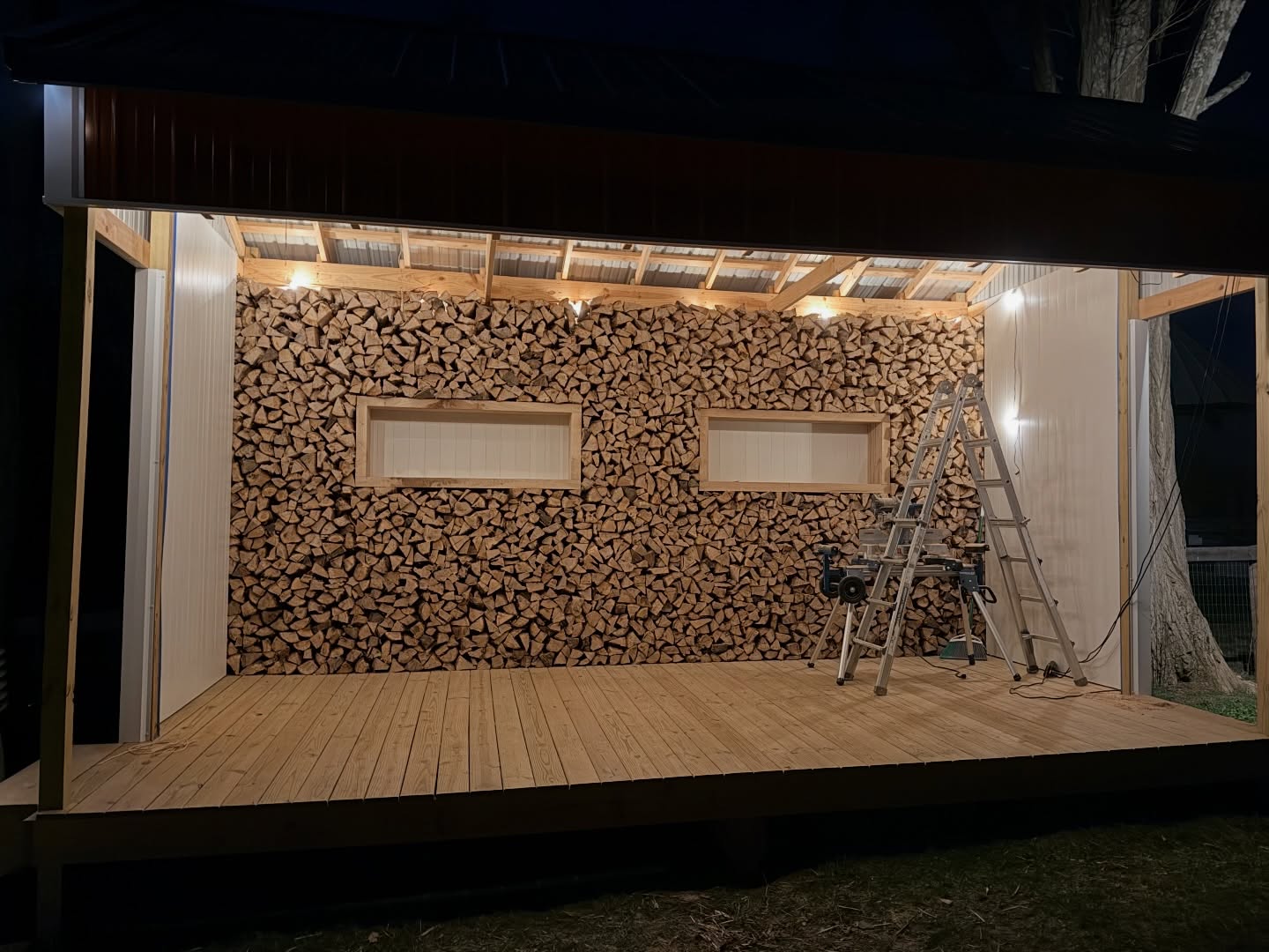 Our stage got an upgrade! Two full cords of firewood stacked floor to ceiling. We’ll decorate those window boxes seasonally.
It may have been a bit of a crazy idea but I think it turned out pretty awesome, especially lit up at night.
We’re excited to have it as a backdrop for our musicians and for your photos!
#cordwood #firewood #photobackdrop #musicstage
