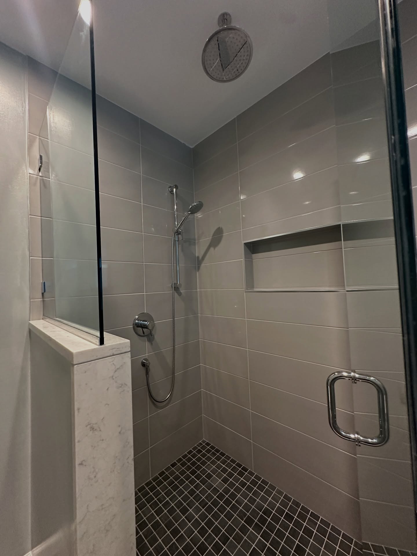 This shower is proof that beauty emerges after overcoming a plumbing issue 🚿🛀
READ ON ➡️
We had already contracted with these clients for a kitchen renovation/ first floor renovation when they showed us a plumbing leak coming from their 2nd floor primary bathroom. Unfortunately, this bathroom had recently been renovated by another contractor and the shower pan and walls were not installed properly which created a leak to the downstairs.
These are never great situations because:
1. We never like speaking negatively about another contractor
2. We also were very aware that this bathroom was brand new.
BUT unfortunately the shower needed to be redone. So we removed the shower door, plumbing fixtures and stone to reinstall. Properly waterproofed the shower and prepped it for new tile installation. Installed new shower floor and wall tiles that we found at @thetileshop and reinstalled the plumbing fixtures, stone and shower door.
And just like that, their bathroom is new again - beautiful but more importantly safe to use!
This is just another example that you don't have to demo everything to get the results you are looking for, whether it be through a problematic situation or just a renovation on your to do list.
Our family is here to walk you through all your best options when renovating your home! 203-778-9385
#showerdesign #bathroommakeover #bathroomrenovation #bathroomdesignideas #bathroomdesignideas #bathroomdesigner #bathroomcontractor #homeimprovementproject #homeimprovementcontractor #homeimprovementdesigner