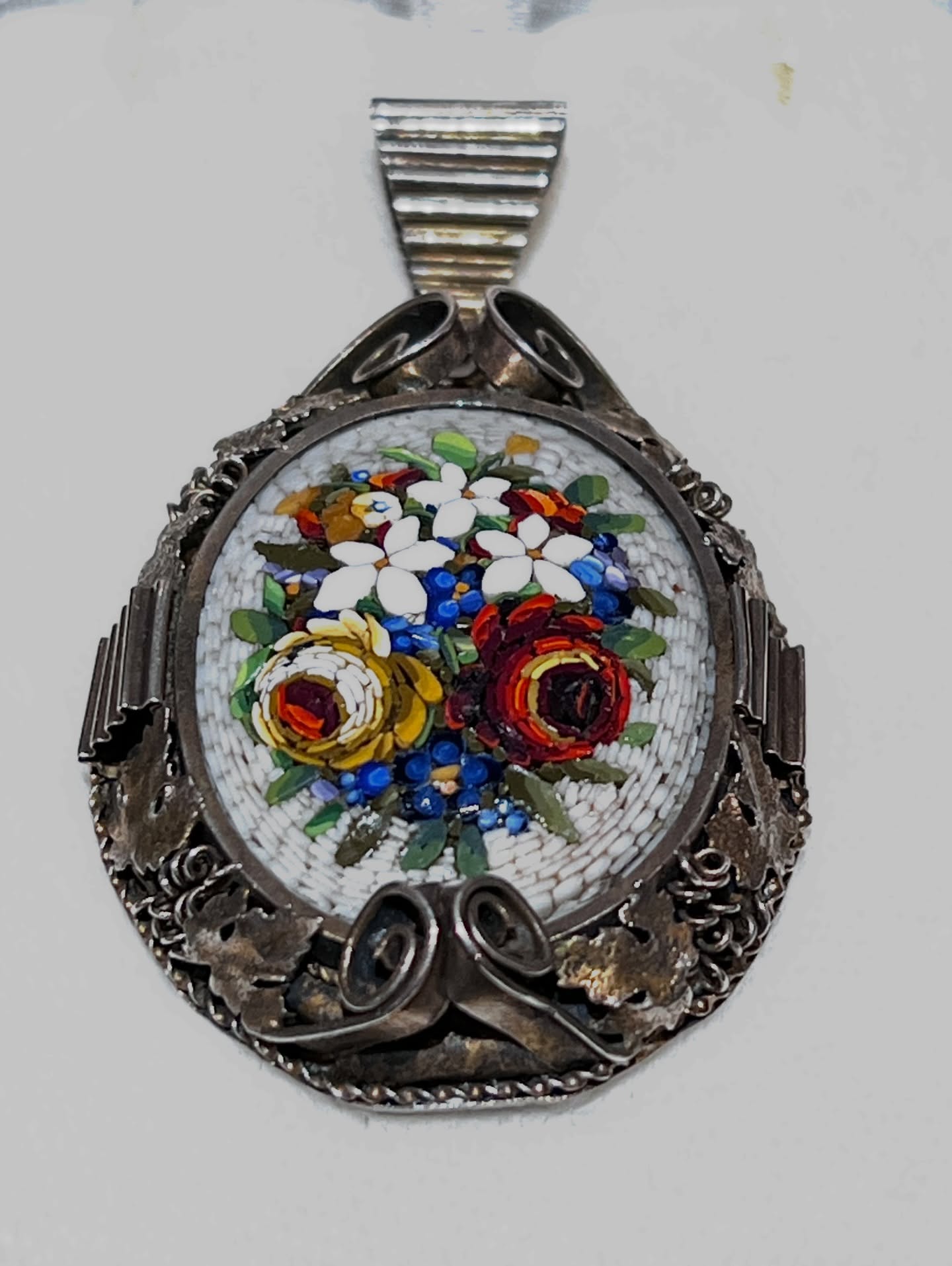 Italian Micromosaic Pendant • c. 1880–1920
A beautifully detailed Italian micromosaic pendant, depicting a vibrant floral bouquet composed of finely cut glass tesserae. The craftsmanship and color are exceptional, framed in a decorative silver mount that enhances the delicacy of the mosaic without overpowering it.
Intricate, hand-made, and timeless — a lovely example of late 19th to early 20th century Italian mosaic work.
DM for details.
#ItalianMicromosaic
#AntiqueJewelry
#VictorianJewelry
#MosaicPendant
#CollectibleJewelry