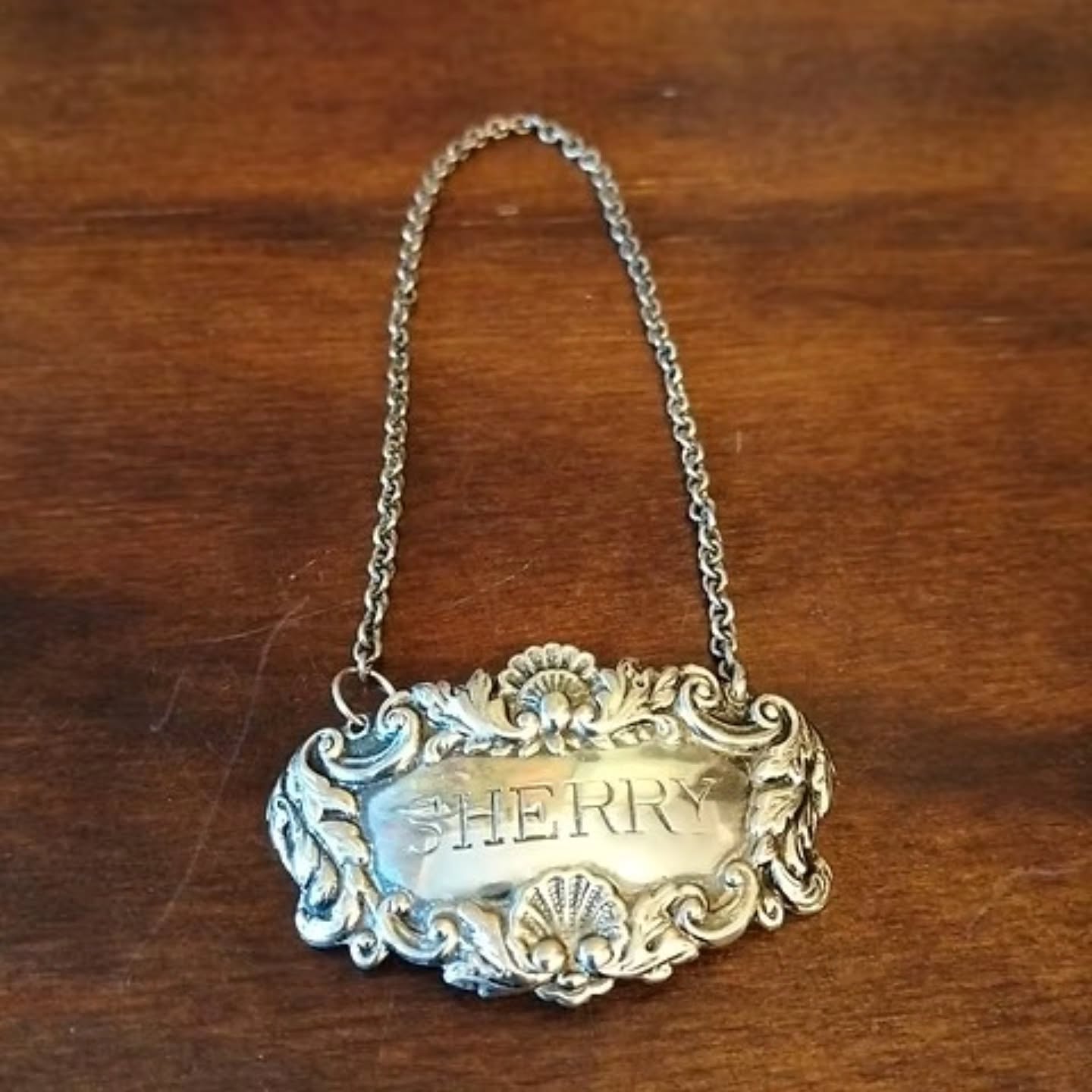 Vintage sherry decanter hanging label possibly silver but no hallmarks | https://share.google/KMwcDxEYRkngeTlWe