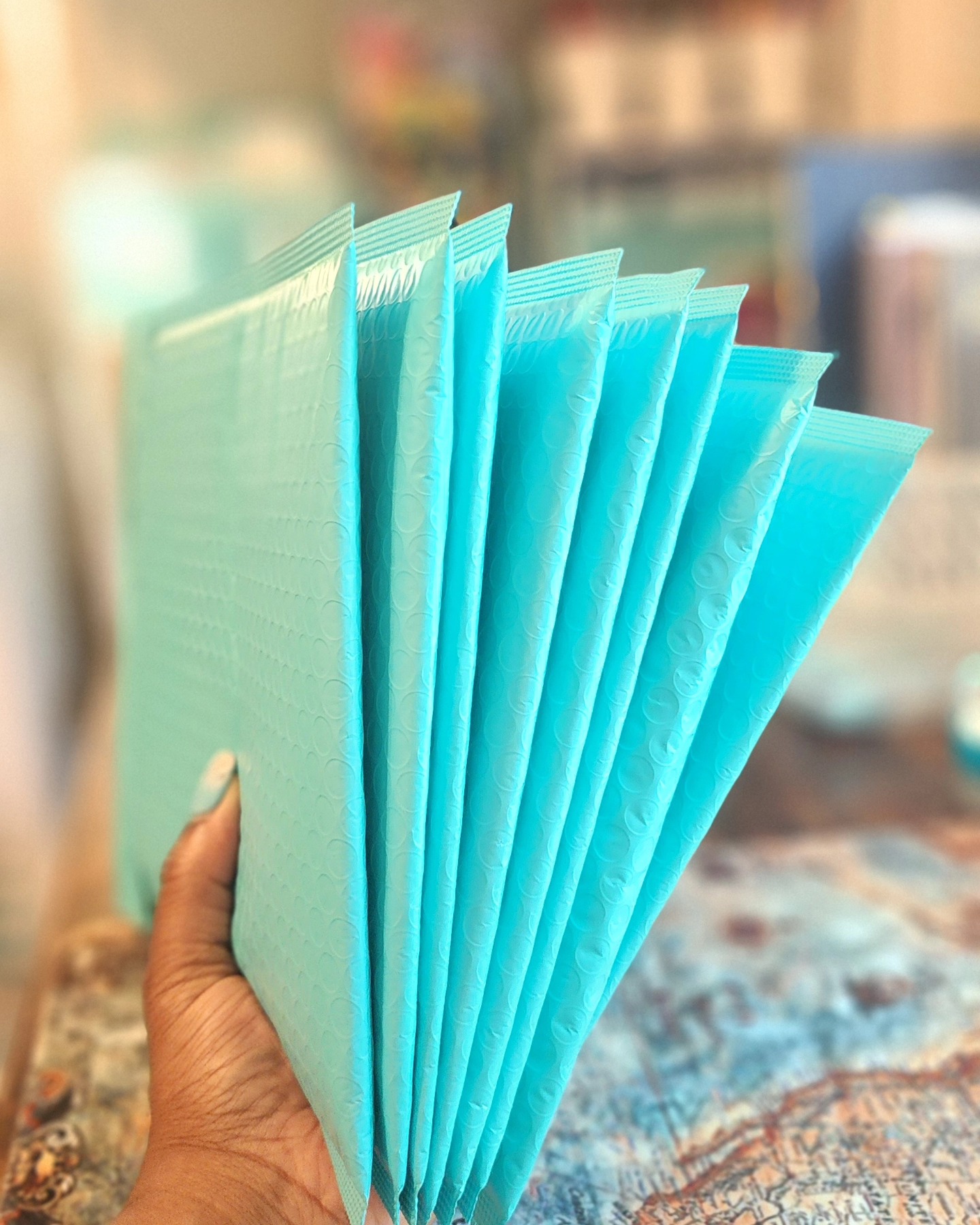 ✨️All the orders in my queue have been shipped, and Patreon's Sandra Mail is packed and ready to label and ship!
Working a few minutes each day is challenging and sometimes frustrating, but it gets the job done!! Don't underestimate the power of working your way through things one step at a time!!
Photo description - holding a stack of turquoise bubbewrap envelopes in one hand that are ready to ship to customers.