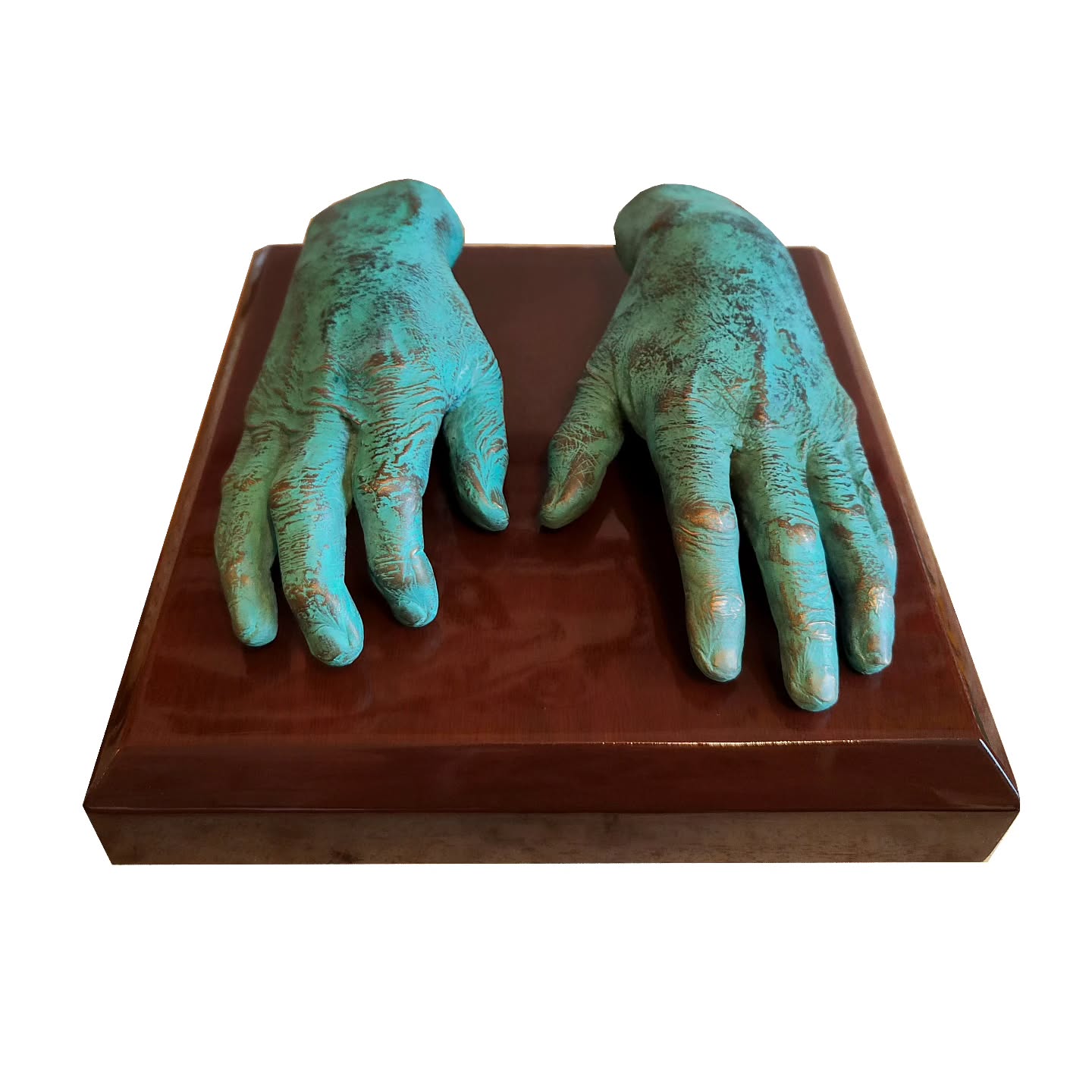 Foundry bronze casts of a late husband set onto solid polished mahogany. These castings were originally taken in November 2024. It is often the way with memorial castings, it takes time. Grief is the hardest emotion to navigate. It creeps up on you unaware.
Something seemingly simple can suddenly fully disturb your day, it's not always the big dates and anniversaries. It's often the little things. Their absence can feel deeper than words could ever explain.
As such I don't mind pausing, sometimes it's not right to rush into a decision. These castings nearly became many things. We paused with them cast in bronze in early summer, until the mahogany was found, carved and polished to match his piano.
They rest in their new home and can bring comfort when there is sadness.