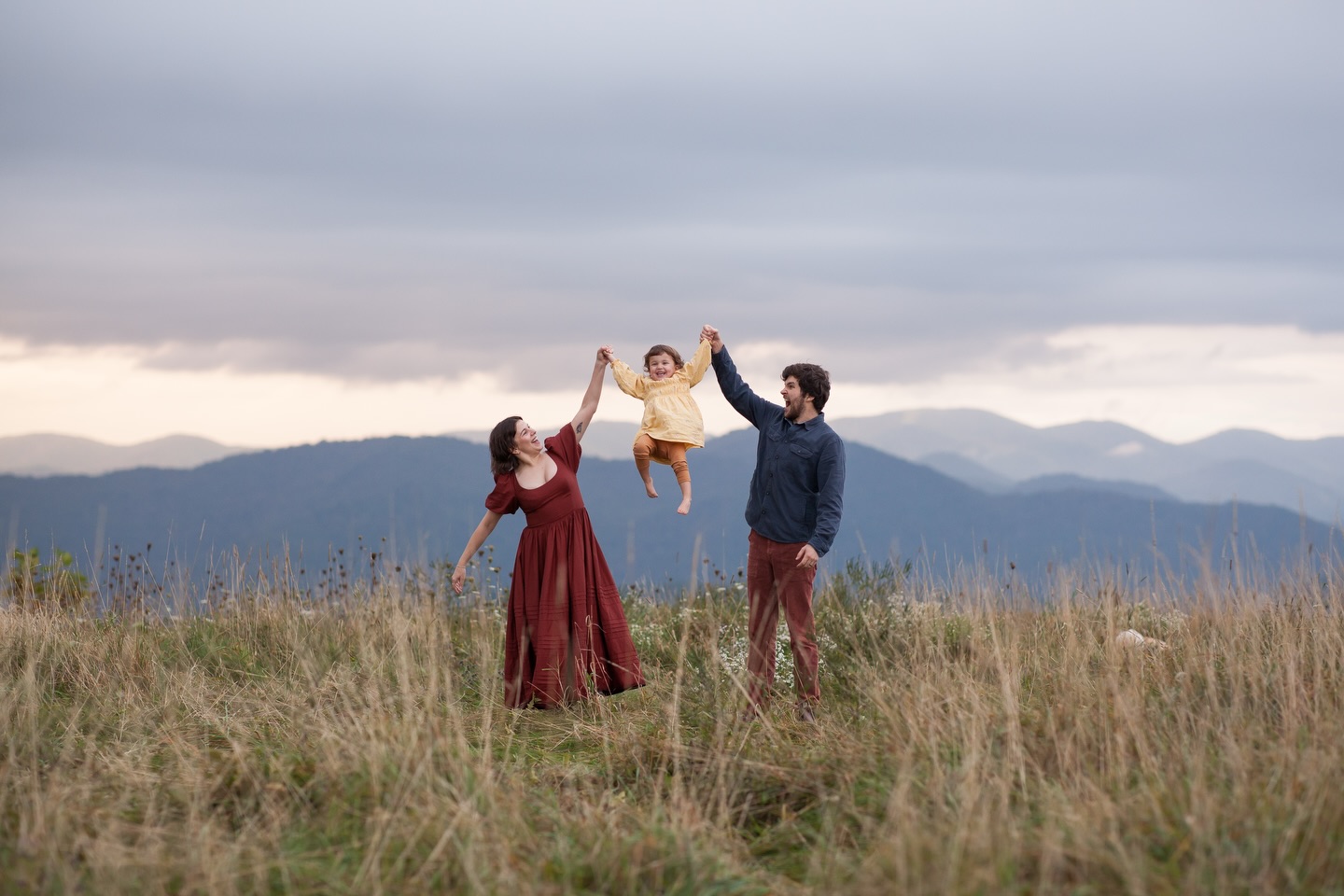 The sky cracked open. Rays of light struck down onto what felt like infinite layers of blue ridges. A gentle mist in the air embraced her hair with dew that brought out her curls. With playful feet, they ran, spun, tossed, and loved on their daughter wholeheartedly. Pure presence. Bursts of laughter, squeals of joy, and smiles that reflected the absolute miracle of life itself. Nothing else existed, but this moment. right. here. On top of the world, with her entire world.
For the mother who wants to remember this feeling. Of what matters most. Of letting go, and getting lost in the moment with her greatest loves.
Into the Wild Sessions :: Spring and Summer books now open 🌸