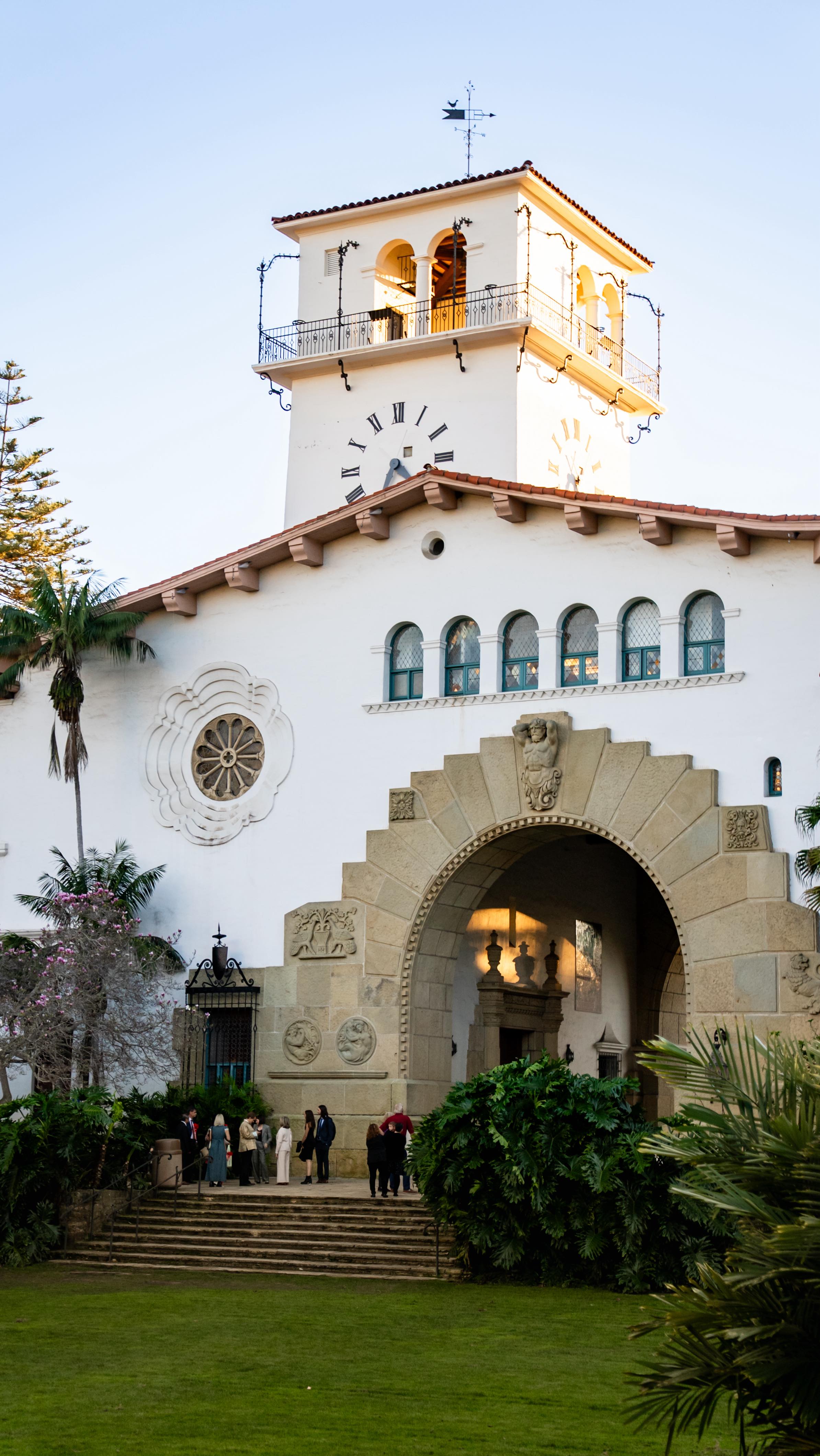 The Santa Barbara Courthouse is more of an ornate fortress than your standard American courthouse.
It’s also a productive marriage factory, churning out approximately 4,000 marriages per year. On high-volume days, 60 couples tie the knot.
To build the Spanish Colonial Revival–style courthouse, they initially budgeted around $700k, but the final bill came out to nearly $1.4 million. Whoopsies!! Turns out burying a massive steel skeleton inside concrete walls is structural overkill and hand-painted tiles aren’t sold at bargain prices.
On top of that, in 1929, there was a high import tariff on foreign instruments. Bells that were any good came from Europe. A proper set of bells would’ve set them back $30k, about half a million dollars today.
So for 50 years, the courthouse clock sat silently ticking away.
In the 1980s, they installed a speaker system, but it wasn’t connected to the 1929 clock pendulum, so the bell sound rang off-sync.
In 2012, they connected the clock mechanism to a modern computer and sound system; it was finally synced up.
Or was it? Since the clock relies on physics, the metal rod can shrink and expand with the weather, so its measure of time speeds up slightly during colder months and someone has to tune it.
Not only are the bells fake, so is the ceiling “wood,” which is actually concrete poured into wood molds and painted brown. They were terrified of the fire hazard of actual wood.
Perhaps my favorite fun fact of them all is that from 1929 to 1971, prisoners enjoyed Riviera sunrise views over the mountains, while judges and lawyers admired unobstructed views of street traffic.
There are local stories of tourists driving into town in the 1940s and ’50s, seeing the jail building, and walking to the entrance with their luggage, assuming it was a luxury hotel. The sergeant would tell them, “We have rooms, but you don’t want to stay in them.“
Sources:
SB Courthouse Website
SBTHP
Goleta History
Noozhawk
Montecito Journal
Atlas Obscura
Wikipedia & Wikimedia
SBPL
UCSB