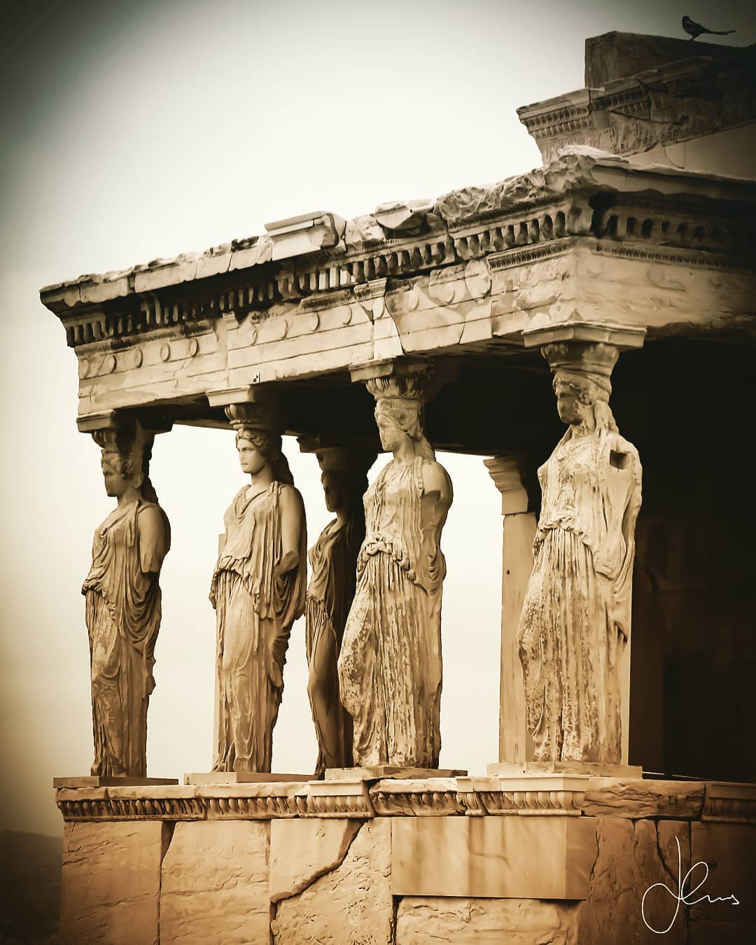 🏺🏛❗ I present to you the timeless beauty of the Caryatids that function as female architectural columns with resplendent sculptural detail especially in their hair on the south porch of the Erechtheion (406 BC) a deeply sacred temple on the Acropolis of Athens dedicated to both the goddess Athena & the god Poseidon. After 2,500 years on the Erechteion in 2008, five of the six Caryatids were transferred to their current home in the Acropolis Museum of Athens. The remaining “sister” stolen by Thomas Bruce, Lord of Elgin (1766-1841 AD) still resides at the British Museum in London since 1816. In Athenian folklore, the Caryatids lament every night for their sister awaiting the day they will be reunited! Potentially / most likely they were sculpted by Alcamenes a Greek sculptor from the island of Lemnos and pupil of the “godlike” in skill sculptor Phidias (5th c. BC).
◾◾◾
Ironically as legend states the Caryatids were not actually from Athens but rather from the Peloponnese and specifically a town outside Sparta called Caryae. Symbolically their use as support columns represents their punishment by Athens as they committed treason and sided with the Persian Empire in the Greco – Persian wars!
◾◾◾
I don’t even want to imagine all of the archaeologists at the edge of their seats for the 70-minute journey when the Caryatids relocation that was conducted using three tower cranes transferring metal boxes with the Caryatids inside between the old and the new acropolis museum took place in late 2007 early 2008! When you visit pay attention to the backside of the Caryatids as the way their hair is “styled” varies significantly from column to column (the sculptural marble craftsmanship displaying fluid excellence remains the same nonetheless)!
◾◾◾
❗Date of Visit: Nov 19, 2019
Weather Conditions: Afternoon visit around 17:00 (Winter Sunset) - It was very humid, and it rained shortly afterward.
◾◾◾