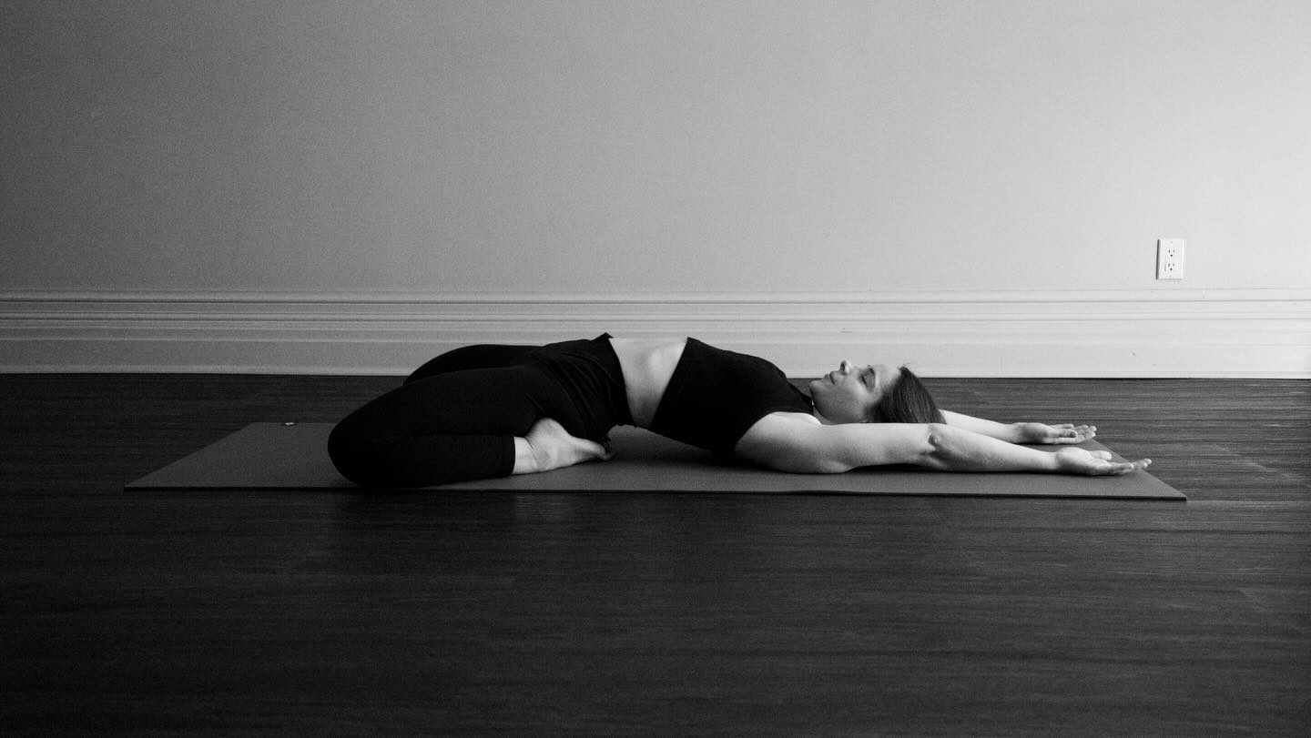 SLEEPING HERO POSE — Supta Virasana 🌙
In Sanskrit, supta means “reclined” and vira means “hero.” This pose invites us to soften into stillness while staying courageous enough to feel what’s present.
Sleeping Hero Pose is a deeply introspective shape — one that asks for patience, honesty, and a willingness to modify. It is not about depth, but about listening.
Body:
Supta Virasana offers a deep stretch for the quadriceps, hip flexors, knees, ankles, and tops of the feet, while gently opening the chest and belly. Because this pose places significant pressure on the knee and ankle joints, it’s essential to move slowly, use props, and come out at the first sign of pain (not sensation—pain). Supporting the back, hips, or thighs with bolsters or blocks can make this posture more accessible and safe.
Breath:
The breath flows into the front body here — expanding the belly, ribs, and chest. Each inhale invites spaciousness; each exhale encourages surrender. Let the breath soften any gripping, especially around the hips and thighs.
Mind:
This pose teaches humility. It reminds us that heroic effort isn’t always about pushing — sometimes it’s about resting, adapting, and choosing compassion over intensity. Mentally, it cultivates patience, self-trust, and deep listening.
Sleeping Hero Pose invites us to rest in awareness — brave enough to modify, wise enough to pause, and gentle enough to receive.
Reflect on this the next time you settle into this shape.
📸 @candice.ferreira
.
.
.
.
.
#suptavirasana #sleepingheropose #yogatherapy #mindfulmovement #yogalife
