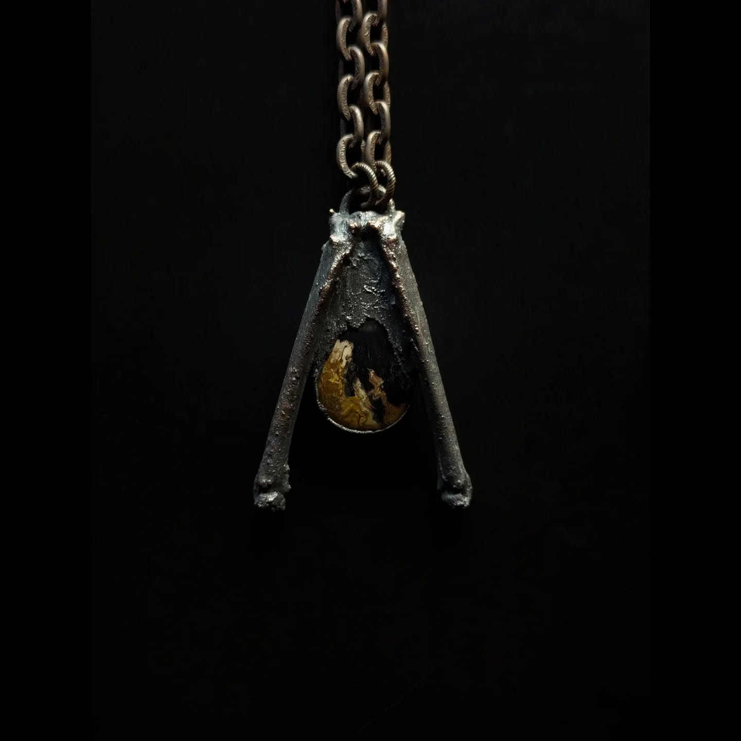 An amulet for The Morrigan, Celtic Goddess of death, war, and fate--the air and the sovereignty of the land.
Invoke her to walk into the fires of your fears, battling to shapeshift them into wisdom.
the palm root stone brings deep transformative earth energy, shielding against negativity
found fox bones for protection, sharp clever action
plated in copper- the great conductor of energy
#themorrigan #warriorqueen #battlegoddess #shapeshifter #goddessworship #triplegoddess #samhain #celticfolklore #pagan #wheeloftheyear #darkseason #adornment #magicamulet #worshipinthewoods #praytothewilds #myallegiancetonatureistotal #forestfound #vultureculture #bonejewelry #copperjewelry #forestgoth #darkfolk #alchemy