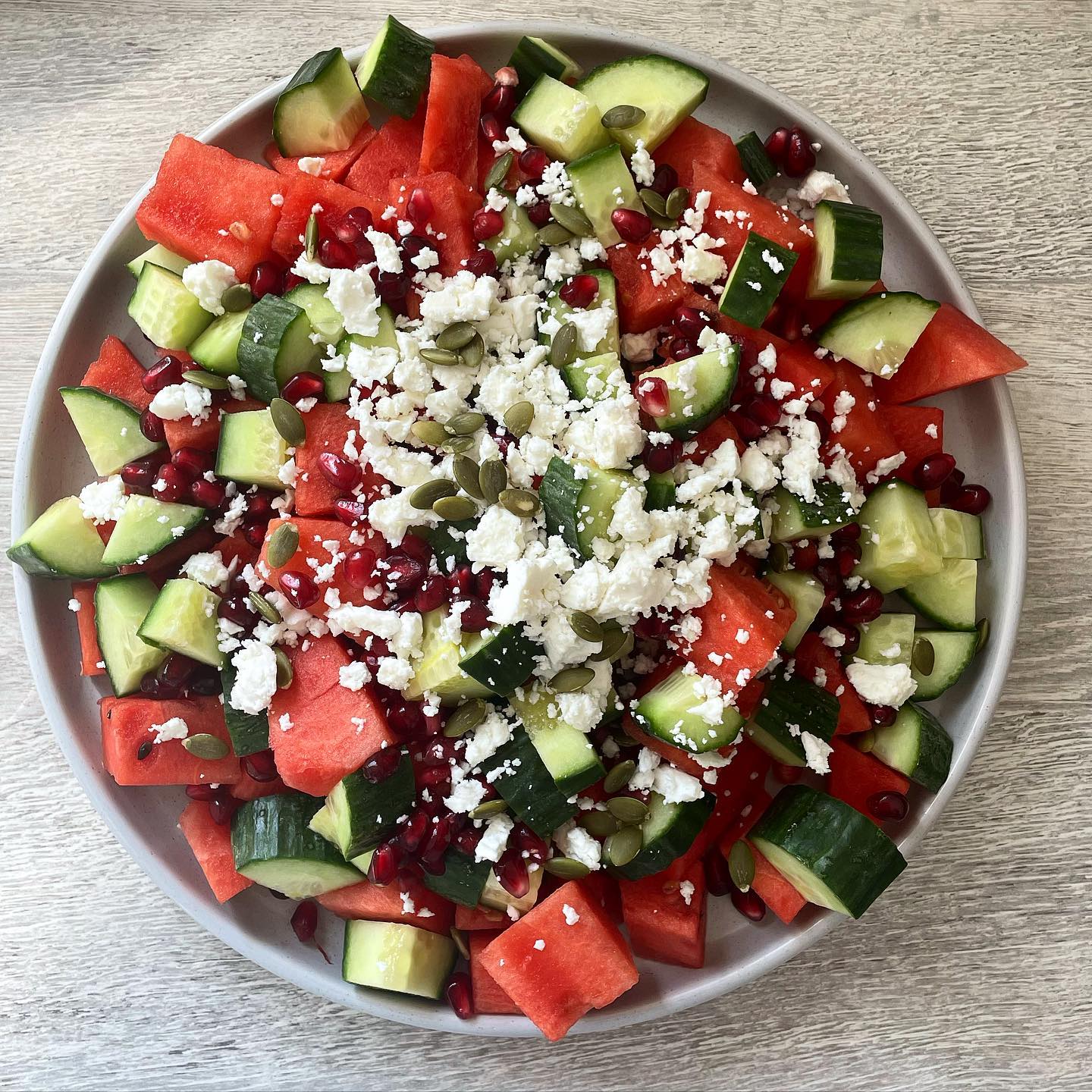 Sunshine on a plate 🌞 Watermelon, cucumber, pomegranate, feta and pumpkin seed salad 🥗
