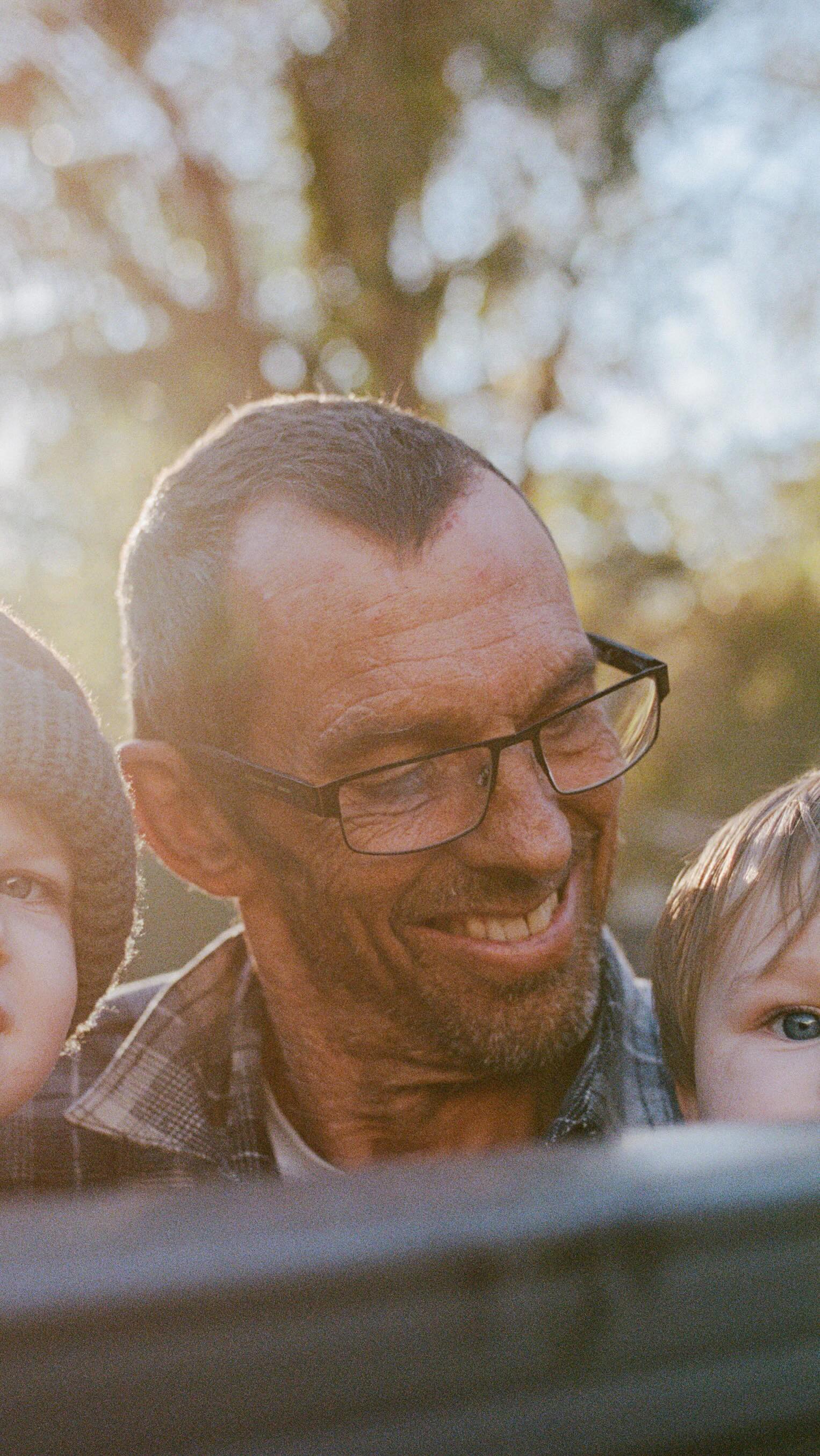 A shared fence.
Two years of borrowed time.
Living next door to my parents in their granny-flat while we build our home is a gift I didn’t know we needed so deeply. Forever grateful.
It meant my boys & I got moments with their Poppy that can never be replaced. Quiet, ordinary days that turned out to be everything.
This afternoon light still stops me in my tracks. I remember grabbing my camera, thinking about how beautiful the sun looked & wondering how it would turn out on 35mm film. He was recently diagnosed. We didn’t know what we were in for. He was already so weak, but still determined to lift them as high as he could.
A couple of months later, he was gone.