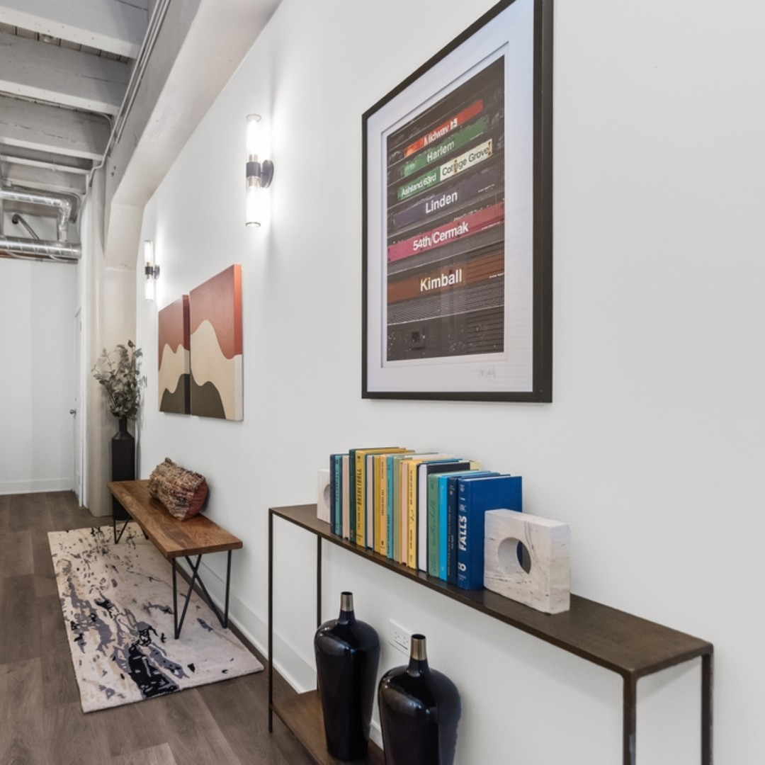 Pops of color and visual interest break up the white wall space, and add fun and functionality to this entryway! #colorful #popofcolor #fun #functional #chicago #chicagorealestate #havenhomestager #chicagohomestaging #stagingworks #stagingsells #staging #homestaging