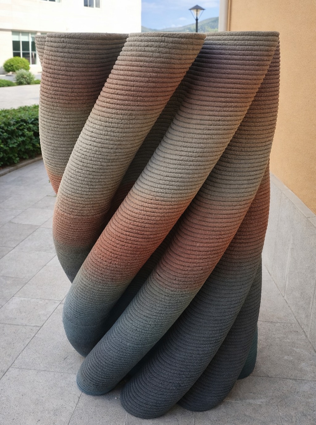 A vertically oriented cylindrical form with a pronounced twisted geometry.
The surface follows a continuous helical pattern,
creating a strong sense of rotation along the height.
Layer lines remain uniform, emphasizing the spiral motion.
A gradual color transition appears across the form,
adding visual depth to the twisted, layered structure.
#3dconcreteprinting
#twistedgeometry
#spiralform
#layeredmanufacturing
#colorgradient
#digitalfabrication