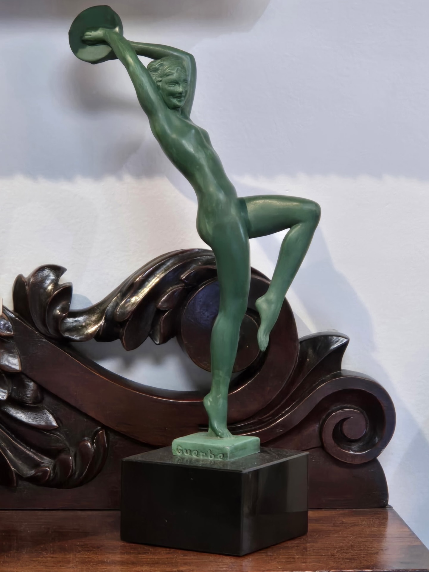 Art Deco Tambourine Dancer
by Raymond Guerbe for Le Verrier, circa 1925
A striking Art Deco patinated metal figure depicting a nude tambourine dancer, poised in an expressive, rhythmic stance with arms raised and one leg lifted in motion. The elongated form, fluid musculature, and confident balance reflect the dynamic elegance and modernist spirit of the 1920s.
Finished in a rich green patina and mounted on its original black marble base, the sculpture is signed Guerbe in the cast. A classic example of French Art Deco figural design, combining sensuality, movement, and refined craftsmanship.
Height approximately 25 cm.
audience:
#ArtDecoSculpture #FrenchArtDeco #LeVerrier #ArtDecoFigure #1920sDesign
