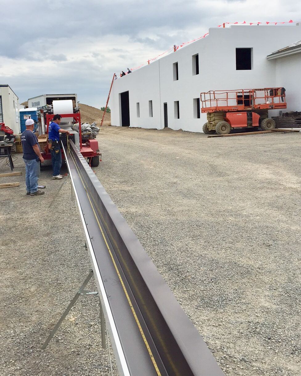 Our 7 inch flange back gutter is perfect for this low slope roof industrial project.