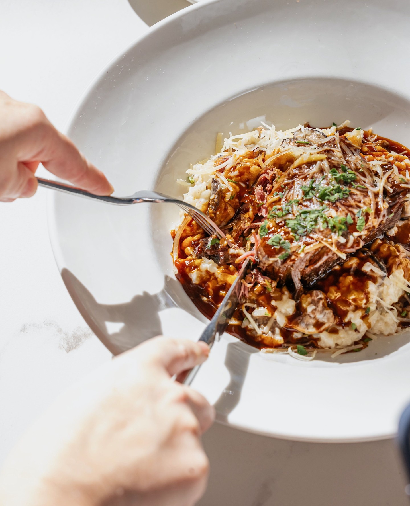slow-braised beef shortrib served over wild mushroom & brussels risotto, finished with rich demi....