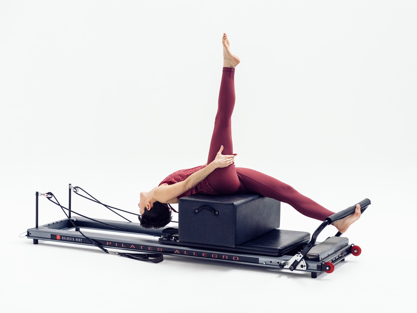 And here is how the exercise progresses after last week's post!
'Climb a tree' is a challenging reformer exercise which helps you improve many skills: flexibility, mobility and strength.
Keeping the gesture leg straight targets your hamstrings (the back of the leg), encouraging them to stretch and lengthen.
The upper back extends towards the floor, which helps mobilise your spine. This feels lovely after a long day sitting at work: finally you can let go of the tension in your shoulders and open them up.
But how do you come back from this position? Well, the core has to work hard to lift your torso, bone by bone until you are sitting up again!
Come to try it out in our studio: our expert teachers will design the best progressions to get you there.
Picture credit: @moonwalk.studio