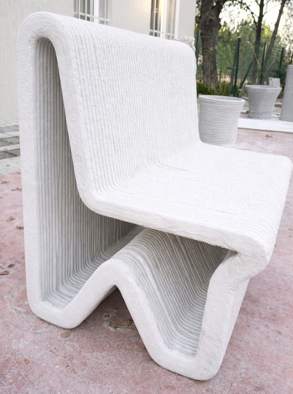 A continuous folded geometry forming a single-piece chair structure.
The form flows from the backrest into the seat
and down into the base as one uninterrupted surface,
with smooth curvature and consistent layer texture.
The geometry is defined by continuous transitions,
creating a rigid yet fluid-looking structure
with a uniform layered finish.
#3dconcreteprinting
#layeredstructure
#freeformdesign
#roboticfabrication
#digitalconstruction
#concretefurniture