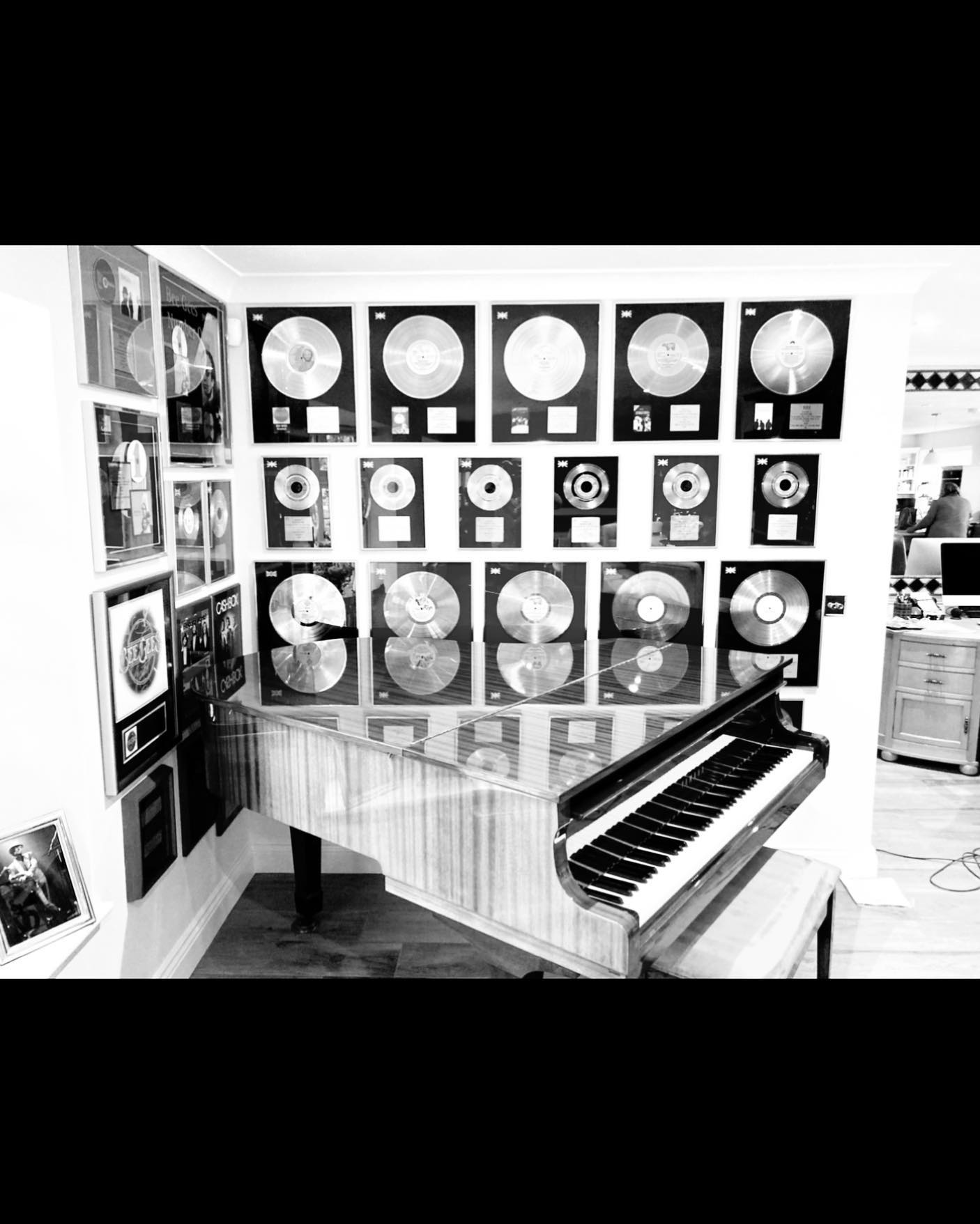 Maurice Gibbs Yamaha Grand along with Records that a Bee Gees enthusiast bought at auction.