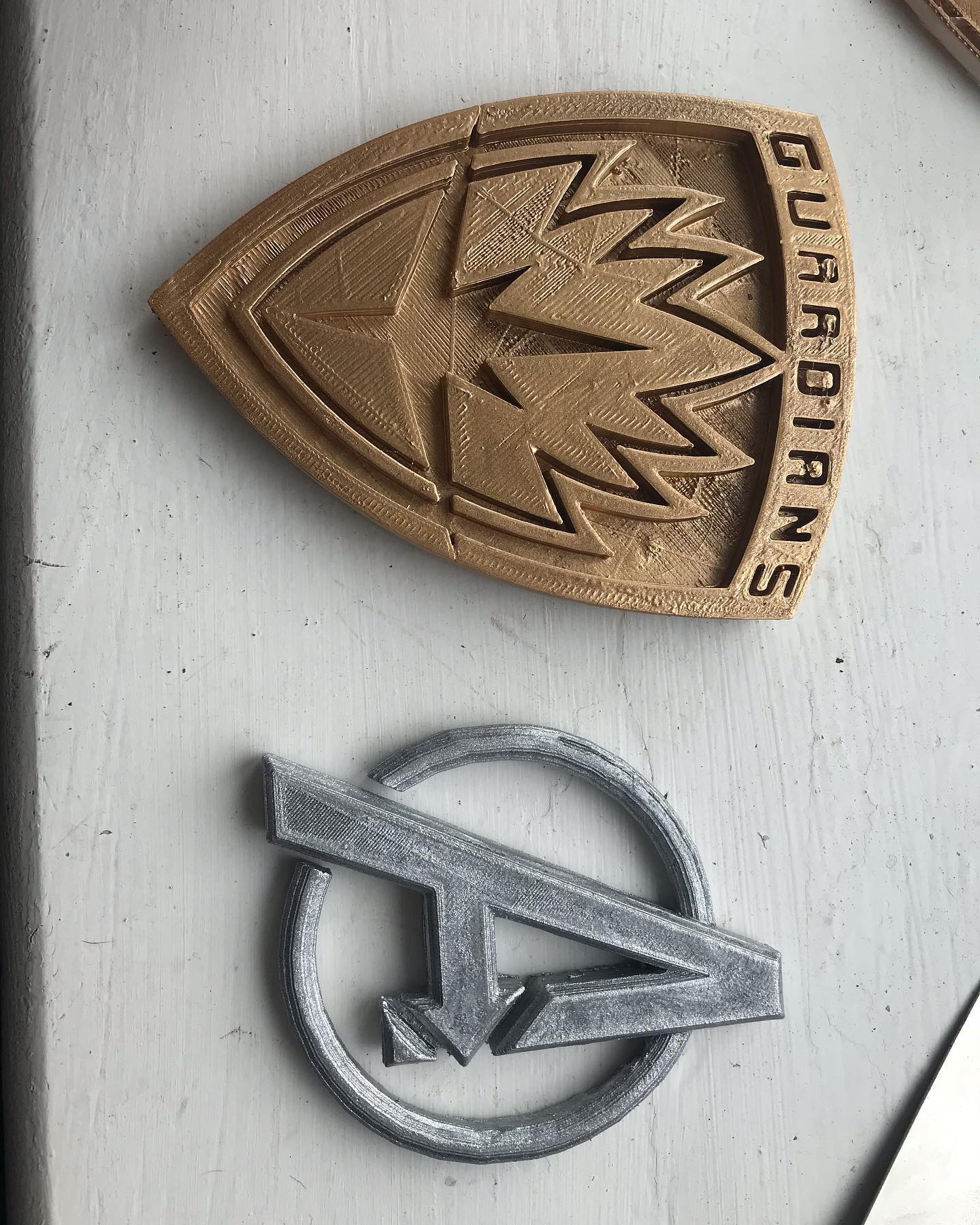 Painted my first 3D models. The gold guardians badge is from thingiverse and the silver avengers logo is the same one I posted the other day. #avengers #guardiansofthegalaxy #marvel #3dprinting #3dart