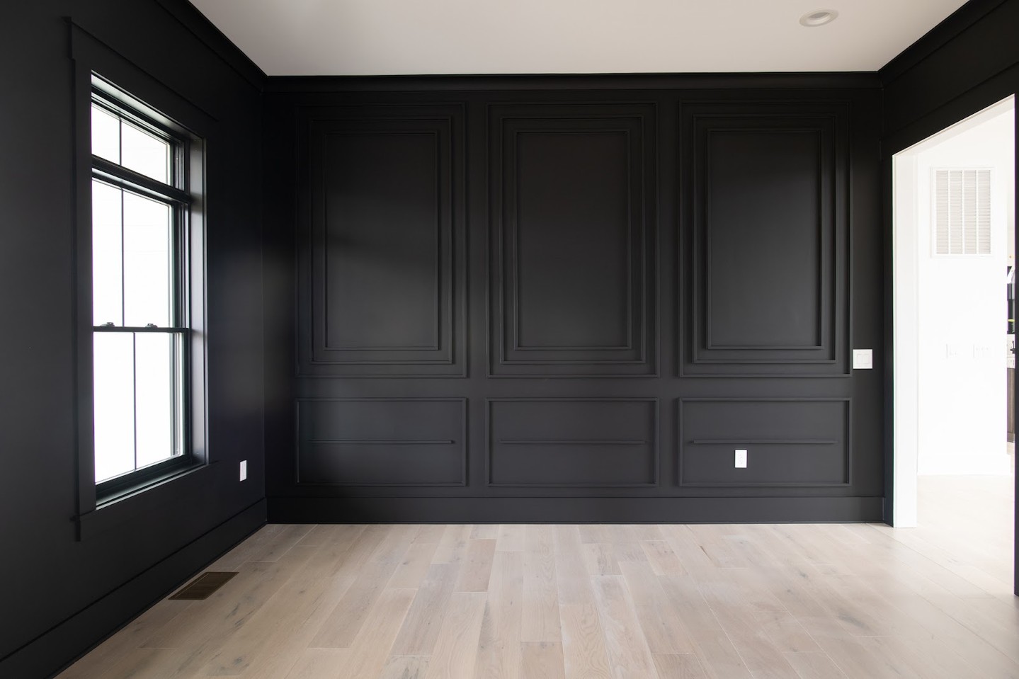 Bold and beautiful! Custom molding paired with sleek black walls creates a dramatic statement that’s as timeless as it is unique.