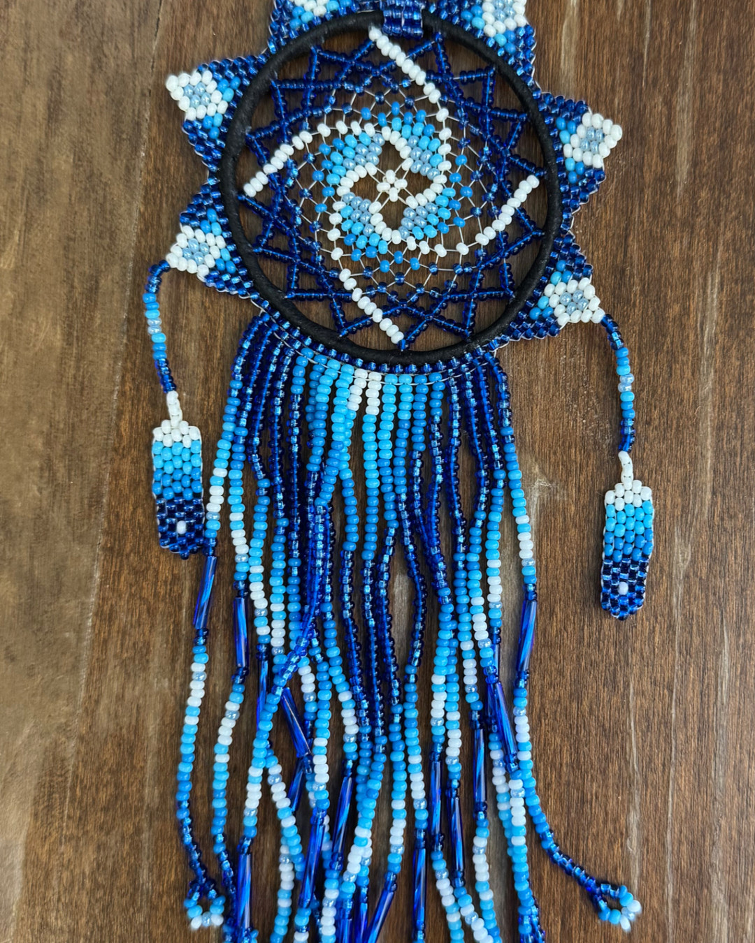Bring home a piece of heritage with our Blue Beaded Dreamcatcher! Handcrafted with love, each detail tells a unique story. 🧵💙 Link in Bio #Dreamcatcher #EthicalArt #IndigenousCrafts