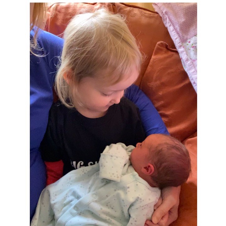 Meeting the new sister for the first time.