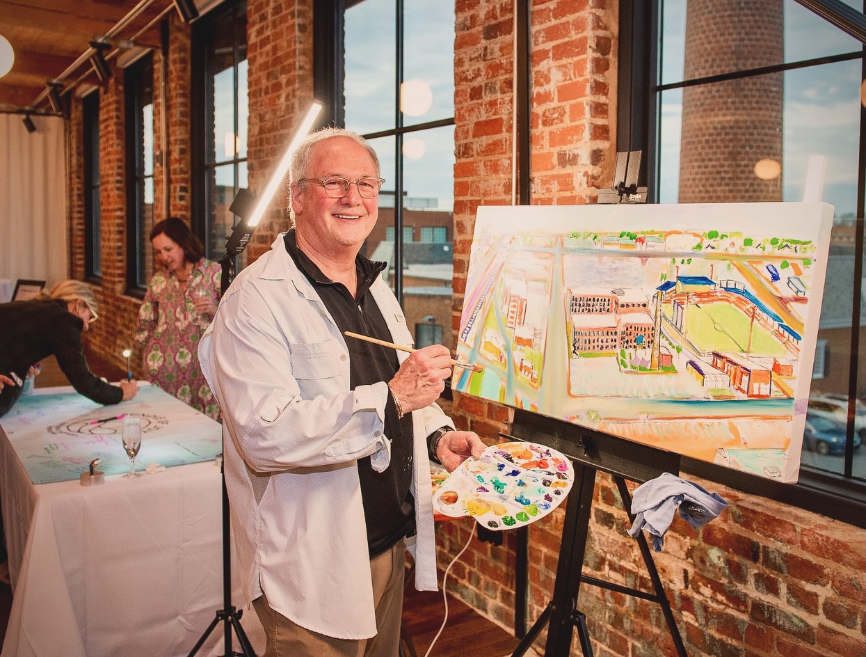 I was thrilled to live paint during the cocktail hour to support the “Bundles & Bubbles” event Jan 22nd raffle fundraiser, an event supporting the @bundleofjoy_highpoint program at the High Point Medical Center, which provides essential baby items and resources to families with newborns in the High Point area.
Congrats to Kay Miller🎉, winner of the drawing for my 29x40” oil painting. Congrats to Morgan Qubein for an amazing growing support for new mothers in our community.
I’m only halfway done with the painting & will continue working on it to fruition.
I so enjoyed working with Shelby Lloyd in planning & developing a unique view of the downtown High Point landscape.
Special thanks to John Conrad to help me with aerial images to piece together a bird’s eye perspective of the downtown area of new development. Photo thanks to @yasminleonardphotography & @slloyd2010
🎨
#landscape #impressionism @downtownhighpointnc #oilpainting #community #supportlocal #ınstart @garysimonci #colour #garysimonci
