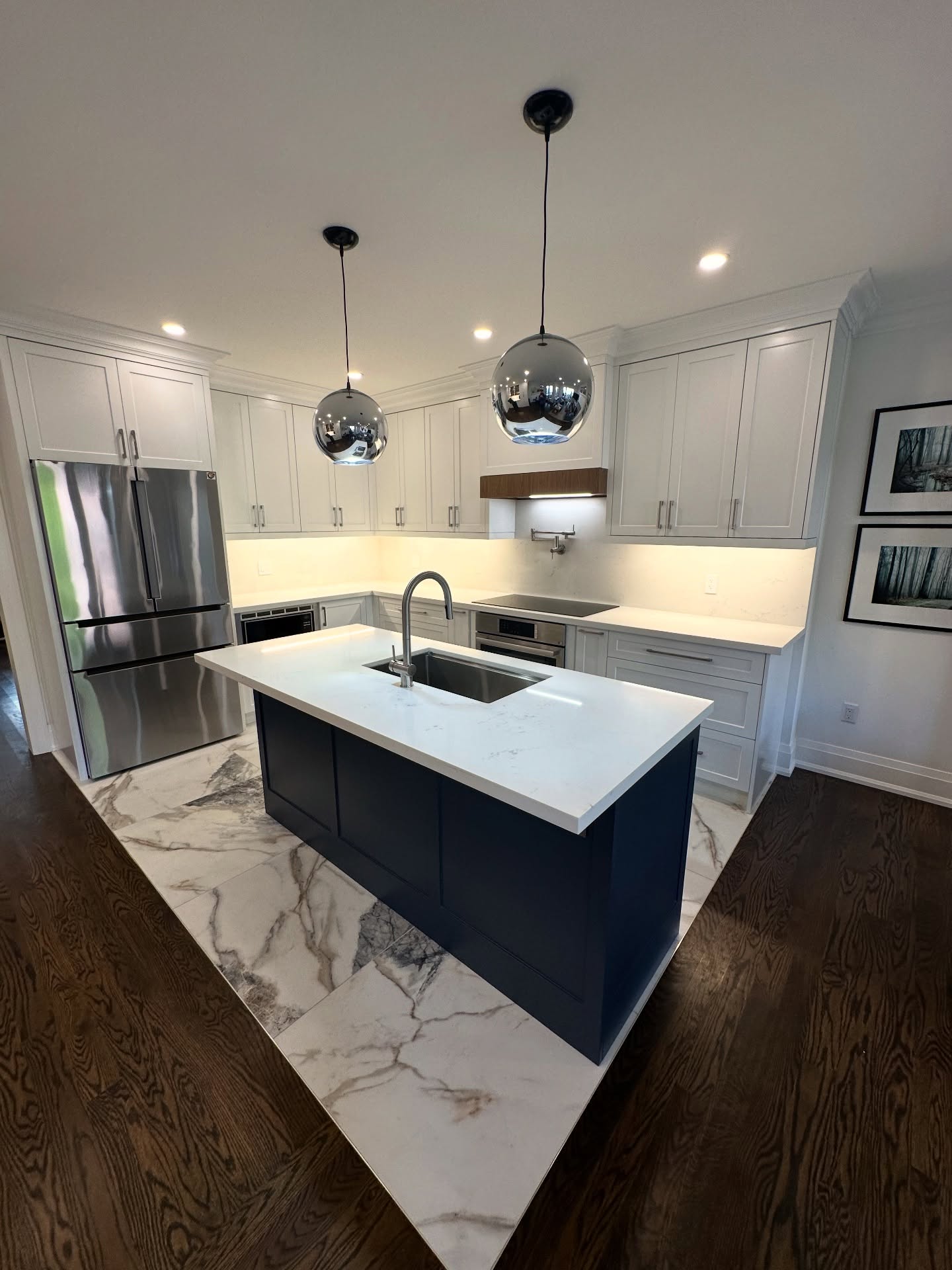 This main floor renovation wasn’t just about updating a kitchen or refreshing an entryway — it was about creating a home that works better from the moment you walk in the door.
Because for busy families, the first steps into the house matter just as much as the space where everyone gathers.
So we designed both spaces as one continuous story.
Starting with the foyer:
• custom built-in storage for coats, shoes, and everyday life
• cabinetry designed around the existing travertine to preserve what was worth keeping
• seamless kick details and continuous crown molding for a built-in, intentional look
• durable finishes that can handle kids, sports gear, pets, and real life
A space that feels calm and organized the second you step inside.
Then into the kitchen — the heart of the home:
• new appliances selected for longevity and performance
• quartz counters flowing into a continuous backsplash for a clean, timeless finish
• oversized tiles to minimize grout lines and create visual calm
• smart storage solutions like deep pantry drawers and drawer-within-drawer cabinetry
• layered lighting and sightlines that keep the space bright and connected
• crown molding carried through to tie the entire main floor together
Every detail was considered — not just for how it looks, but for how it lives.
Because the best renovations don’t feel “new.”
They feel like they were always meant to be there.
Swipe through to see the full transformation ✨🤩💟 #PurpleProperties #TransformingRealEstate
.
.
.
#KitchenReno #TorontoRenovation #TorontoHomes