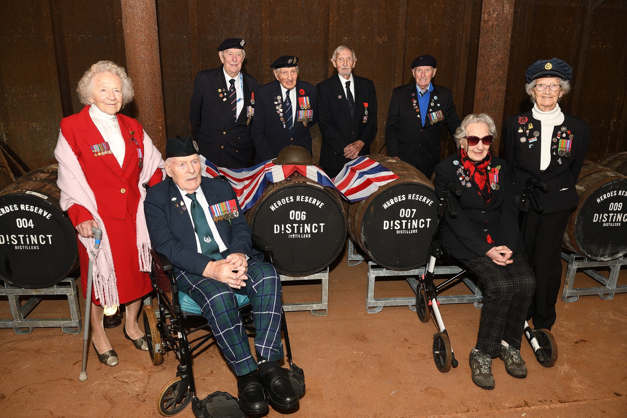WWII veterans were driven to Shropshire to meet the master distiller who created a commemorative 80th anniversary D-Day dark rum.
The Taxi Charity for Military Veterans took a groups of veterans for a two-day break in Shropshire, which included a visit to meet the @distinctdistillers team who have been selling '44', a commemorative special edition D-Day rum which raises funds for the Taxi Charity.
Award-winning Distinct Distillers, based near Ironbridge on the site of a WWII fuel depot, welcomed a group of eight D-Day veterans, one who served in Operation Market Garden and a veteran of the Burma campaign. The veterans enjoyed homemade cakes before a tour of the site, which included a visit to one of the old underground fuel tanks where casks of rum are stored. The master distiller explained how their '44' dark rum is made from the finest molasses and aged in sherry and bourbon barrel oak chips with notes of demerara, caramel and coffee.
Hannah Boon, MD of Distinct Distillers, said:
"The Distinct Distillers' team felt so privileged to have these WWII heroes on our site. We were delighted when the charity accepted our offer to visit our distillery and we were keen to explore how we could raise additional funds to support their work with veterans. After the popularity of the 1944 Dark Rum, we’re expanding our plans with the charity further and will be releasing another line ready for VE day in 2025. We have also launched our Heroes Reserve Cask Programme, which are available to purchase with a £350 donation per cask going to the charity. We also laid down 12 barrels, each one dedicated to those veterans who visited, and we’ll mature these for five to seven years until ready for release."
Dick Goodwin, Vice President of the Taxi Charity for Military Veterans, said:
"The Commemorative D-Day rum has raised over £750 to support our work and it was really fascinating to see and hear how it is made and to visit the huge underground tanks which store the casks under perfect conditions. Later that evening, the team from Distinct Distillers visited our hotel for a rum tasting which went down very well, especially with our naval veterans!"