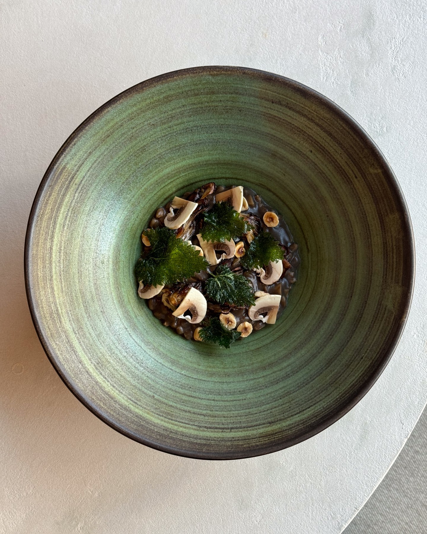 As part of our vegan menu, mushroom and spelt porridge is served with roasted maitake mushrooms, hazelnuts and nettles. A beautifully delicate dish, packed full of umami flavour.
