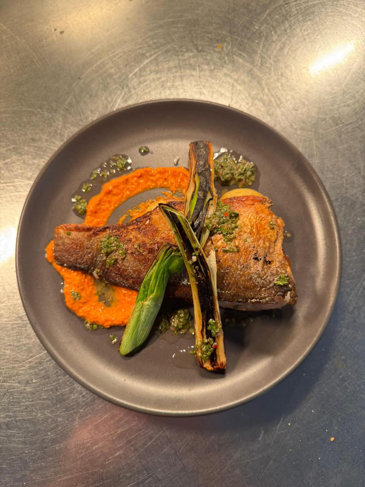 Pan fried Seabass, Charred Calcot Onions, Crushed New Potatoes, Romesco, Salsa Verde #bassintheplace #gimmesomebass #turnupthebass