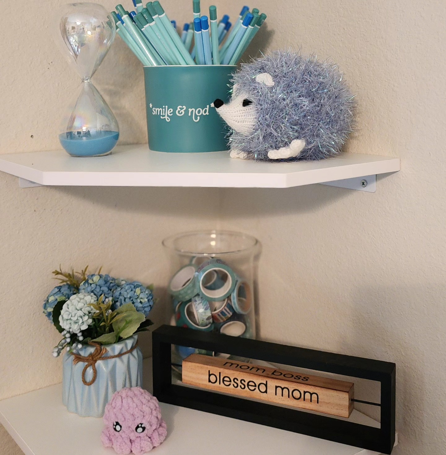 🩵✨️ Surround yourself with things that make you smile! These floating shelves make facing a corner while i work so much more enjoyable!
Ollie the octopus by @crafty_microbes 💜
Turk the turquoise hedgebob by @bobbieharvey1 🩵
Image description: A view of my white corner floating shelves holding some of my turquoise decorations and signs.
#turquoiseaccessories #turquoisestudio #happyplace #artistmom #artstudiodecor