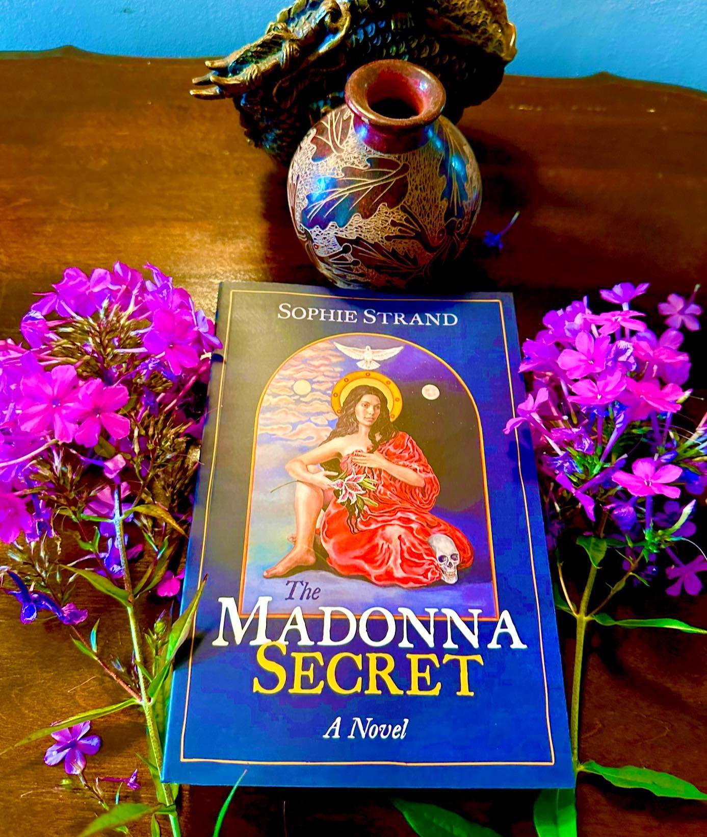 Sophie Strand’s @cosmogyny extraordinary new novel, the MADONNA SECRET, is a rare and essential offering. Sumptuous, alchemical, storytelling rooted in visionary scholarship. This is both a meditation and revelation. Sophie’s telling of the story of Mary Magdalene rewilds our historical assumptions and the sanctimonious myths upon which numerous civilizations have been built, returning them to the fertile Mother Earth and the essential Living Waters of unbroken multi-generational feminine wisdom and lineage. This book is an undeniable visceral experience. I read it at a fever pitch, cover-to-cover, over several days. Paradoxically, I could not put it down and did not want it to end. As I deepened into the story, a vibrant seed was planted that by the end of the book, exploded into a Flowering Tree in the very center of my being. I was broken open. Can a book be a mystical experience? In this case. YES. The “Madonna Secret “ is a living treasure that I will continue to source and reread through the years, both in its entirety and in its holographic passages. If you are to read one book this year, this is it. Sophie Strand, congratulations on an exquisite seminal work! Love, Sarah.:.
~*~
Sophie Strand is a poet and writer with a focus on the intersection of spirituality, storytelling, and ecology. Find out more at www.sophiestrand.com Be sure to sign up for her Substack and read or listen to her other works.