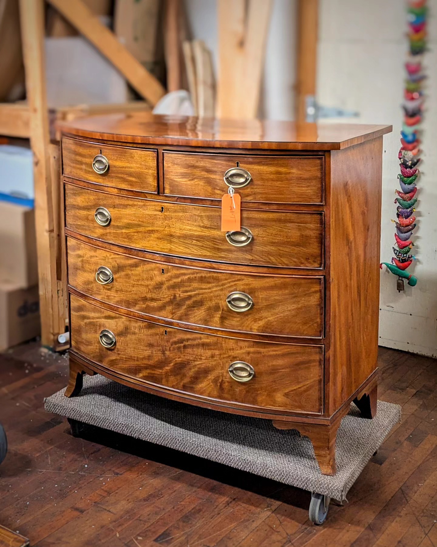 Aside from a few small bits of missing veneer and some missing cockbeading, this bow front chest hardly looks any different than when it arrived at the studio.
Of course, you don't see the numerous small fills, the replaced drawer runner, the resecured half of a drawer bottom, and many areas of lifting veneer that have been corrected. Sometimes a bunch of work is needed to repair furniture, but the end result barely looks changed at all.
#furniturerestoration #furniturerestorer #furniturerepair #mahogany #mahoganychest #bowfrontchest #restoredinbaltimore