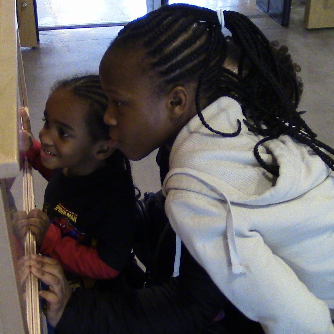 Children enjoying a display at a library.