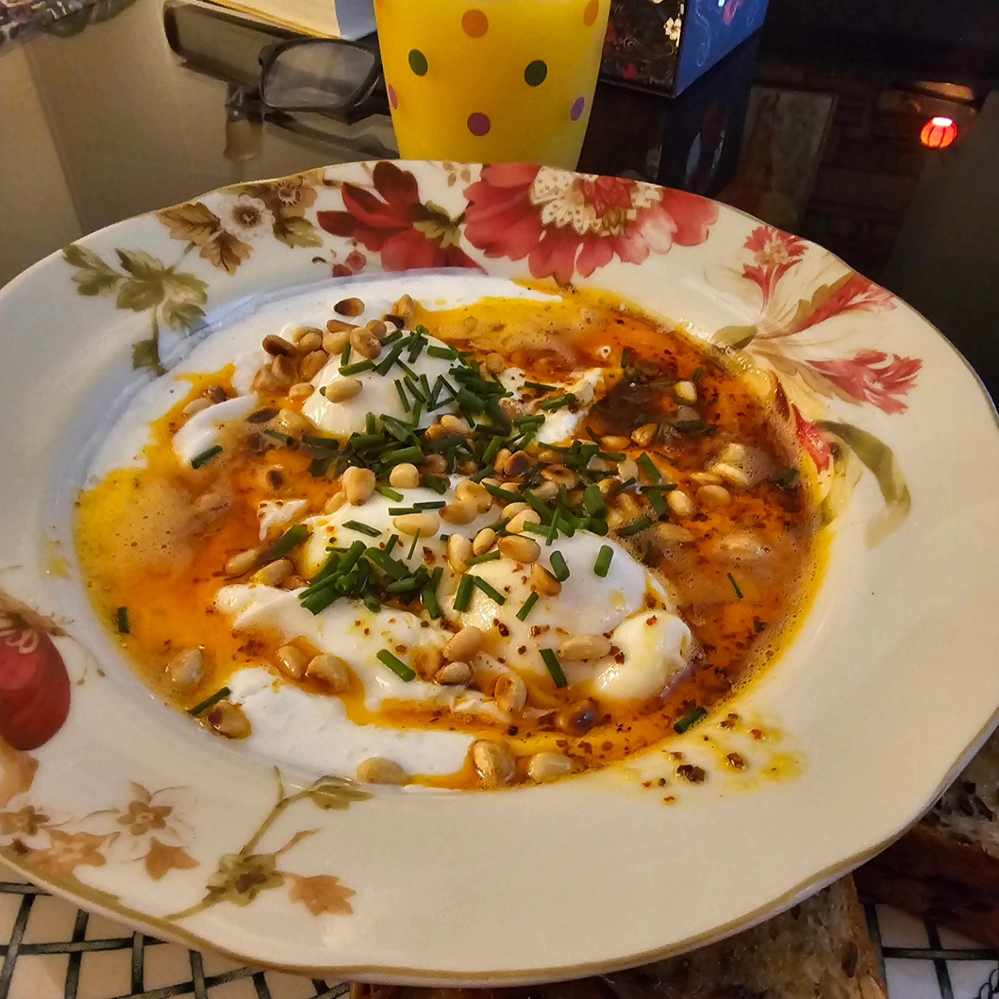 Cilbur. Turkish eggs. Lemon-scented Greek yogurt topped with poached eggs and Aleppo pepper brown butter. Toasted pine nuts and chives. Serve with crispy soldiers (toast slices) for dipping.