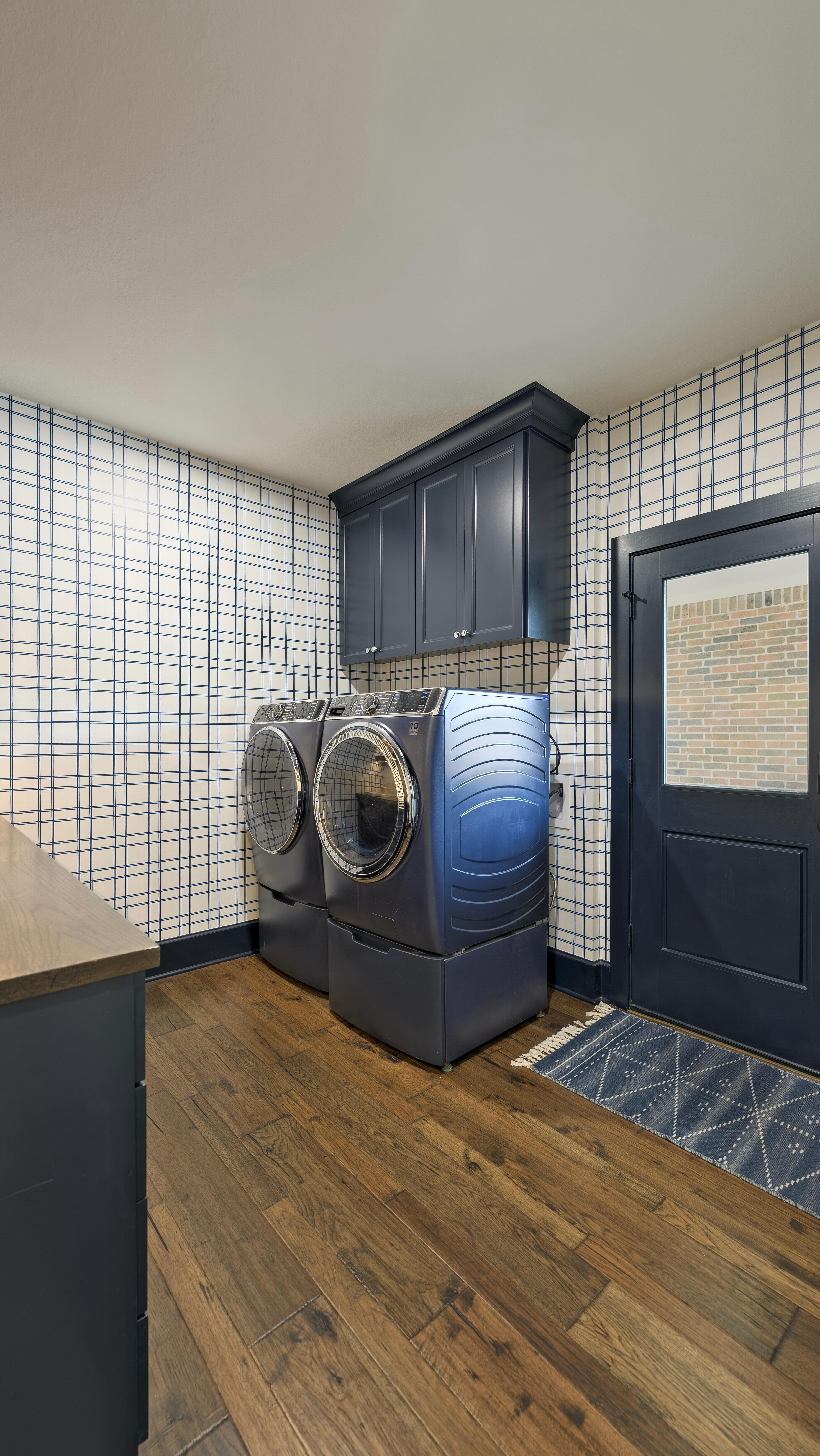 Embarrassing laundry rooms? We don’t know her. 💅
So many of our clients admit this is the room they hope guests don’t notice…even though it’s one of the most used spaces in the house. We think it’s time laundry rooms stop being an afterthought and start being a space that ACTUALLY brings you joy. Because if you’re going to spend this much time in here, it should be both beautiful and functional.
ALSO….can we talk about that wallpaper for a second😍😍😍