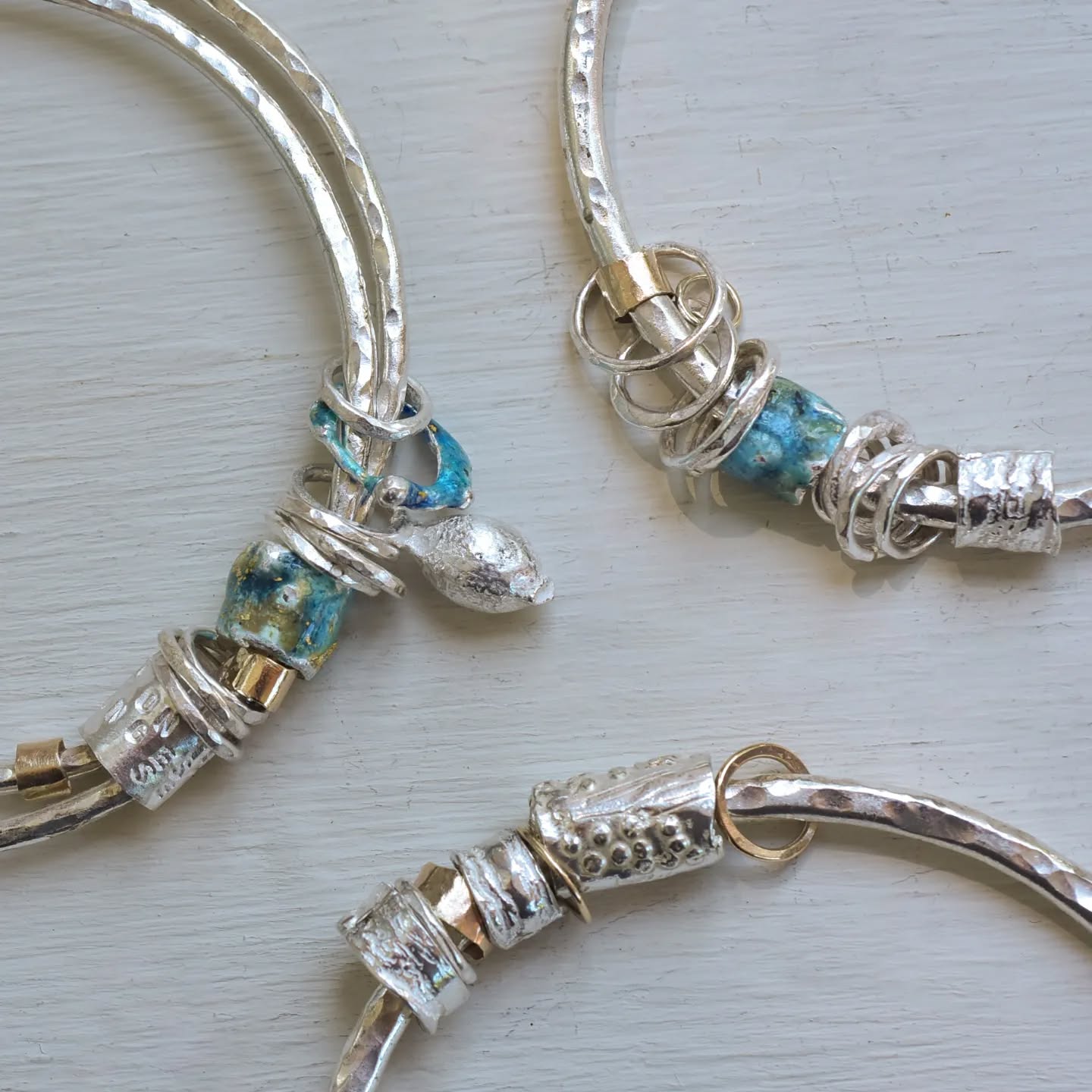 Silver, gold and enamel lettered bangles with all sorts of gnarled texture and pods too. I've been thinking so much about my work- and my business- this week as this month marks 20 years since I registered my business and officially became a full time maker. So much to say but not right now #poetrybangles #custombangles #stillinthegame #Cornwall #designermaker #mixedmetaljewellery #enameljewellery #handmadebangles #hammered #contemporaryjewellerydesign