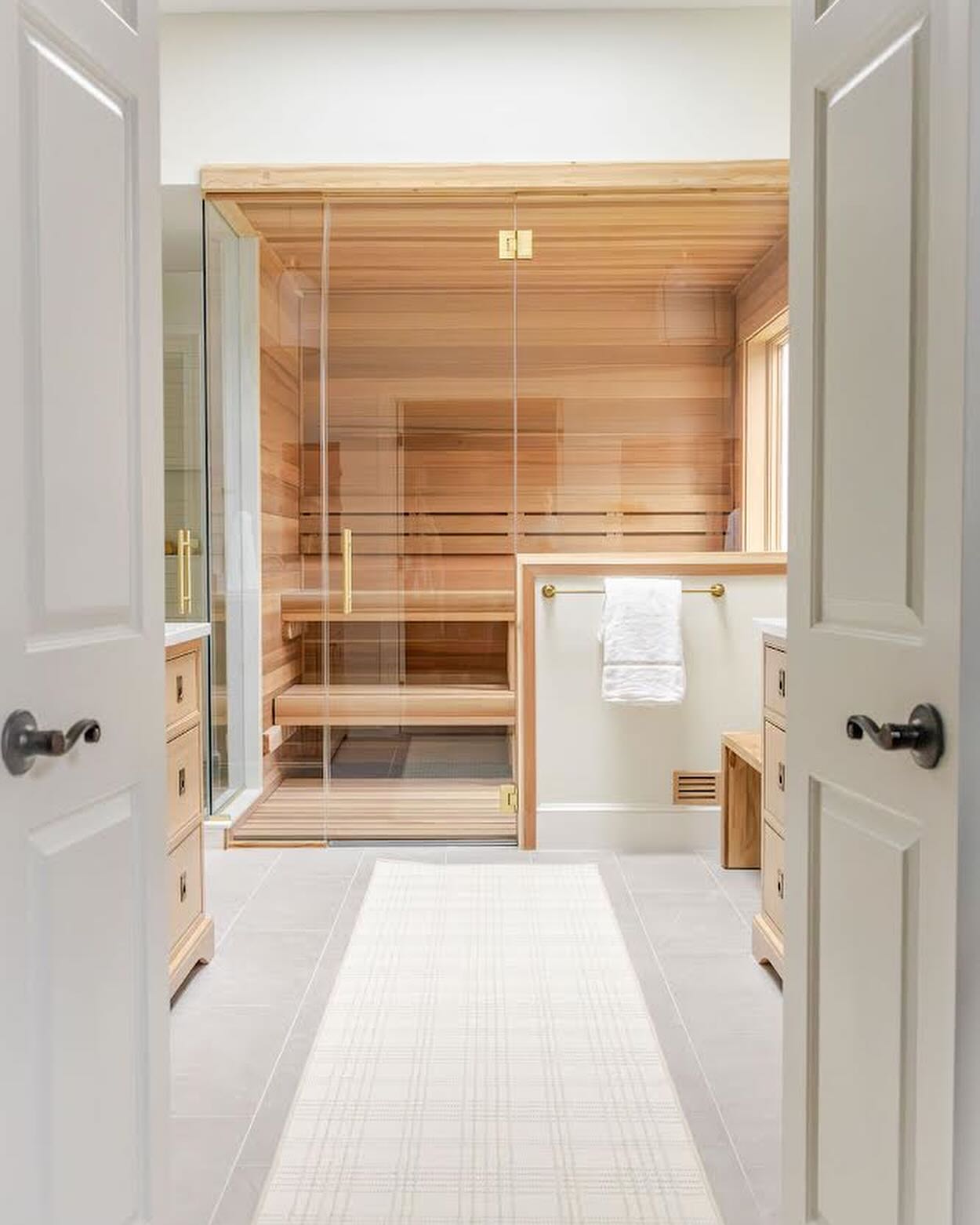 Welcome to our #modernsparetreat primary bathroom.
This project was designed around how our clients truly live. We listened to their daily routines and lifestyle needs, creating a bathroom that supports both function and rest.
From a dedicated place to sit and put on shoes to a large two-person sauna designed for true retreat, every detail was intentionally planned. Thoughtful lighting and warm wood beams draw the eye upward to the 10’ ceilings, enhancing the sense of openness and calm.
A pair of white oak vanities, soft lighting, and natural materials makes the space feels bright, balanced, and serene.
Design // @hillhousedesignmd
Photos // @jlp_yourstory
#PrivateWellnessRetreat #ClientCenteredDesign #LuxuryBathroomDesign #SpaInspiredLiving #WellnessAtHome #CustomInteriors #WhiteOakVanity #ArchitecturalDetails #WoodBeams #QuietLuxury #PrimaryBathroom #ElevatedInteriors #HillHouseDesignMD #marylanddesigner #SPA #SpaBathroomGoals