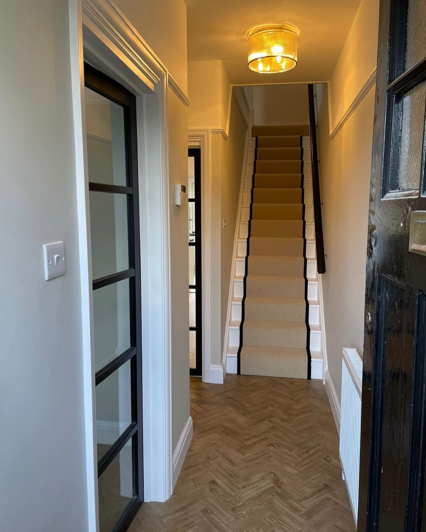 Amtico Herringbone in the hallway with Lano Oasis Carpet in beige edged with black cotton tape stair runner. A perfect combination for this Bickley home.