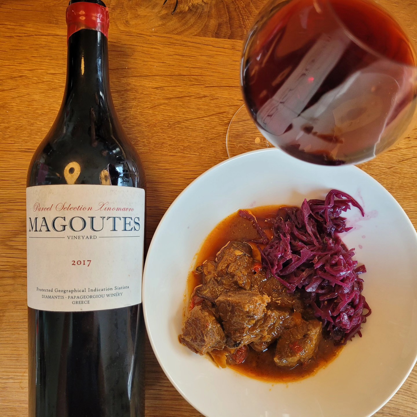 This single-varietal Xinomavro comes from ungrafted, head-trained bush vines - some over a century old - in the @magoutes_siatista vineyard (PGI Siatista, 845–890 m ASL). Yields are tiny, just 0.5 to 1.5 kg per vine. Grapes are hand-harvested and undergo spontaneous maceration fermentation for 30–40 days in large French oak vats, then are raised for 12–24 months in used 500 L barrels. The wine is bottled unfined and unfiltered, with only minimal added sulfur.
Visually, it shows a surprisingly pale hue. On the nose it is however intensely aromatic, with notes of overripe tomato and a distinct vegetal character - think red beet.
On the palate, it reveals an absolutely unique acidity profile, beautifully softened by prominent malolactic development, all supported by a fine tannic framework. This interplay makes it a superb companion to food: it really shines at the table.
The finish is memorable too - roses and cherries linger long after the last sip.
For many enthusiasts, this wine is the ultimate Xinomavro secret - and indeed it eclipses many better-known bottlings from Naoussa. Its quality easily merits 93 points.
Of course, at over €50 per bottle (in Germany you can get it from wineandnature) , a price that reflects the vineyard's uniqueness (look at pictures of it!), one must feel entitled to compare it to the great single-vineyard Naoussa bottlings. In fact, I’ve tasted both the 2017 Vrana Petra and Kayafas from @thymiopoulos.vineyards in recent months. In my view, they offer far greater complexity; ans at least the Kayafas doea so at a quite similar price point. Yet at the dinner table, I’d honestly reach for the Magoutes again - it simply pairs better with food, supporting meaty and gatty dishes perfectly. For pure, casual drinking, however, it’s not my go-to Xinomavro.