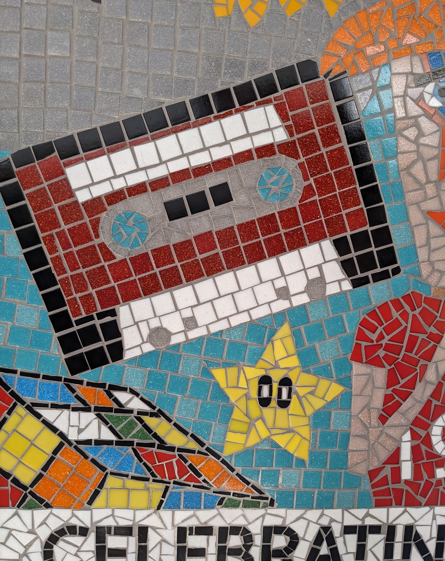 Celebrating 40 years with an incredibly fun and nostalgic timeline themed mosaic. Every element was drawn by a child in the school!
#80snostalgia #davidbowie #cassettetapes #supermariostar #rubikscube #retroaesthetic #glassmosaic #madewithchildren #schoolworkshop