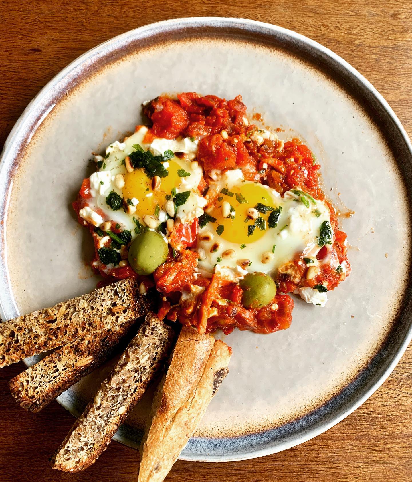 Shakshuka - revised :)
- 250g chopped mushrooms
- 1/2 onion (any type), chopped
- 1 can chopped tomatoes
- 4 eggs
- 30g feta
- Handful coriander
- 2 tsp hot paprika
- Salt & pepper
- Roasted pine nuts
- Few olives
Method:
- Stir-fry in some oil the onion for 5 mins
- Add the mushrooms. Add salt, pepper and paprika. Cook for 5-7 mins on medium heat
- Add the tomato. Cook for 10 more minutes on low heat
- Make 4 holes in the tomato sauce. Add 4 eggs, 1 on each hole.
- Let it cook for 5 mins. Meanwhile toast the pine nuts on a small pan over medium heat (just couple of minutes)
- When the eggs a nearly cooked (but still soft), add the crumbled feta, chopped coriander and few olives
- Serve with toasted bread:)
*
#bruch #shakshuka #shakshukaeggs #vegetarian #breakfast #lunch #healthybreakfast #healthybruch #goodfoods #balancediet #balanceeating #healthylifestyle #healthyeating #nourishyourself #nutritionist #foodismedicine #begoodtoyourself #findyourbalance #honemadefood #cooking #cookfromscratch #cookyourself #inspiration #eatclean #eathealthy #eatlocal #londonlife