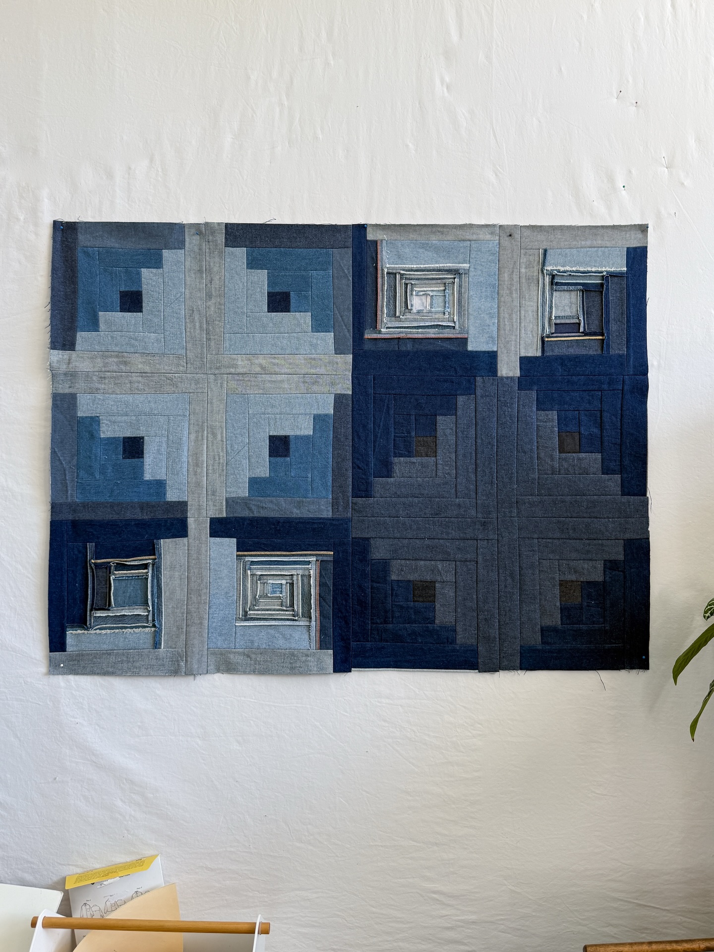 So, these are the log cabin blocks that decided they wanted to be friends. The leather blocks and the rigid denim blocks with selvedge did not want to hang out with these blocks. I totally could have forced them, but that’s not how I work.
It’s always fabric first. Fabric is what guides everything I make – listening to what the fabric wants to do. At first I thought that each log cabin set would be its own piece. But I found this combo kind of interesting, so I’m going forward with this.
It’s not done, I’m adding some more stuff… I think. I’m trying out an idea, we will see if it works. And then I have some thoughts about adding hand quilting to the regular log cabin sets and machine quilting to the inside out blocks… possibly.
And of course I’m already planning a mini log cabin card to chronicle this project 😊