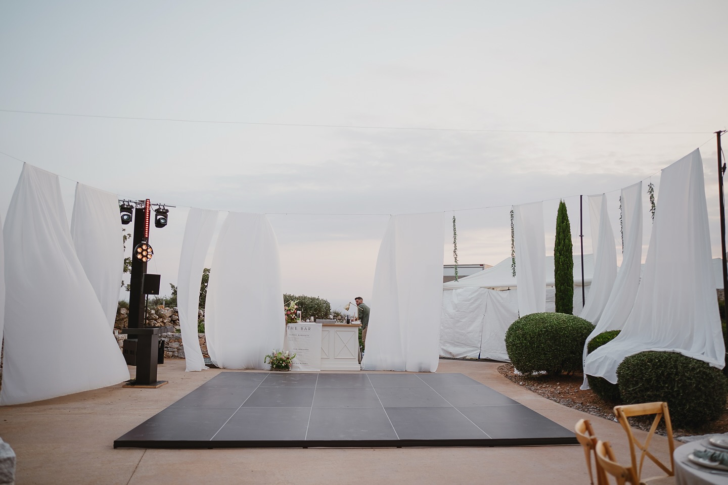 A black dance floor brings a sleek, modern elegance to a wedding reception. Its deep, glossy surface reflects lighting beautifully, enhancing the atmosphere with subtle drama and sophistication. Perfect for evening celebrations, it creates a striking contrast against florals, décor, and attire while making lighting effects and first dances feel truly cinematic. Timeless yet bold, a black dance floor instantly elevates the party and sets the stage for unforgettable moments. 🖤✨