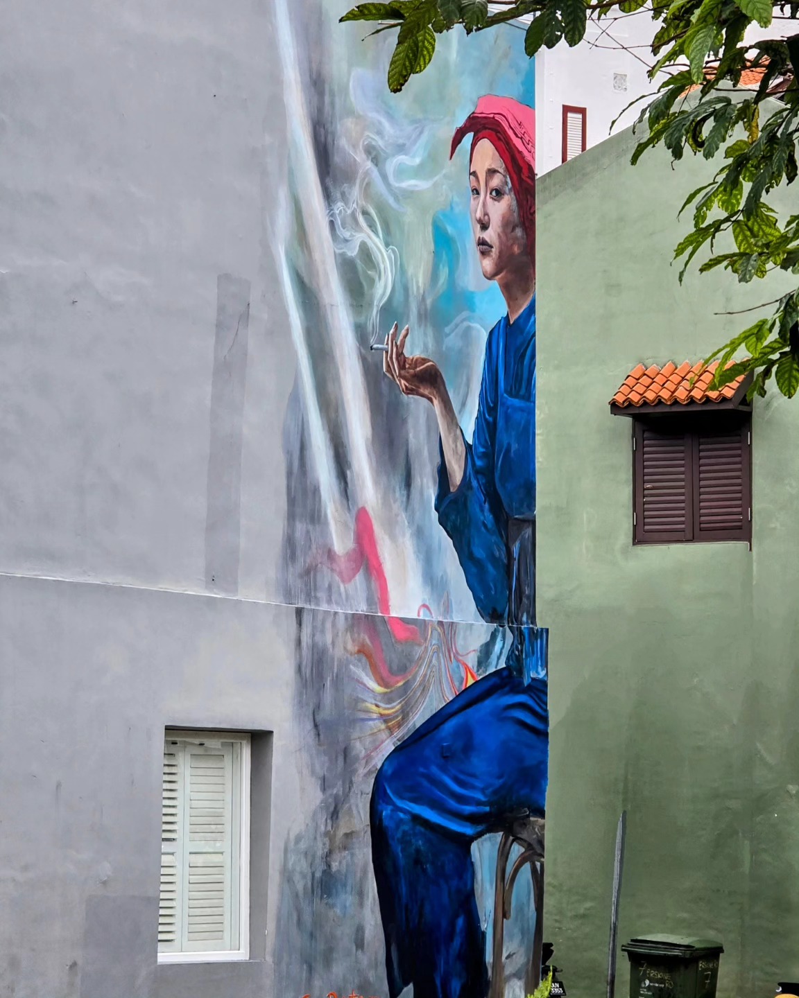 Samsui woman with a cigarette...
Looking at this painting is like ducking into a hidden hawker stall at midnight—there’s a gritty, unvarnished honesty that grabs you by the collar. The Samsui woman’s weathered face and that smoldering cigarette say, “I’ve seen it all, and I’m still standing.” It’s a portrait of hard-earned heritage and quiet defiance—a smoky testament to the spirit that built Singapore from the ground up.
They came from China with an iron will, their red headscarves a badge of honor signaling they were ready to get things done. Long days meant brutal labor on scorching construction sites, often earning just enough to wire precious dollars back home. Through sweat and grit, these women helped raise Singapore’s skyline one beam and brick at a time—an unspoken, flesh-and-blood foundation for the city’s dazzling future.
Like any hard-earned indulgence, those rolled cigarettes weren’t just a habit; they were a moment of personal peace in a life that demanded resilience and selflessness. Tucked into their scarves like hidden treasures, a single puff was a fleeting reminder that they were more than workhorses—they were individuals with stories, dreams, and the courage to keep going when all the odds said stop.