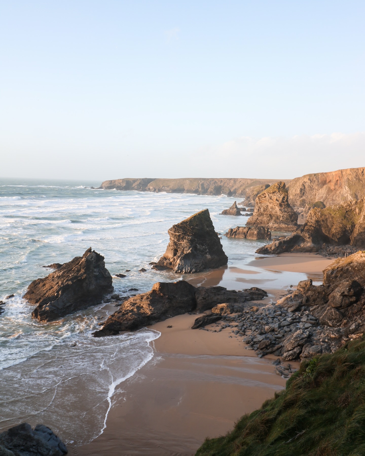 A postcard from the past, January 2023.
Wish you were here, but also… you’d need both hands for your hat. The Cornish coast was all 40mph wind, the kind that made me laugh just to stay upright.
I found Bedruthan Steps at the edge of everything and watched Trevose Head Lighthouse hold steady against the weather. Later, from the warmth of a cabin, I spied the moon caught above the trees, quiet after all that noise.
Wistman’s Wood held a robin perched among twisted branches like something out of an old story, and at Godrevy a cow lingered half lost in the brush, entirely unbothered by it all.
It was a week of wild air, and of memories that still taste of salt.